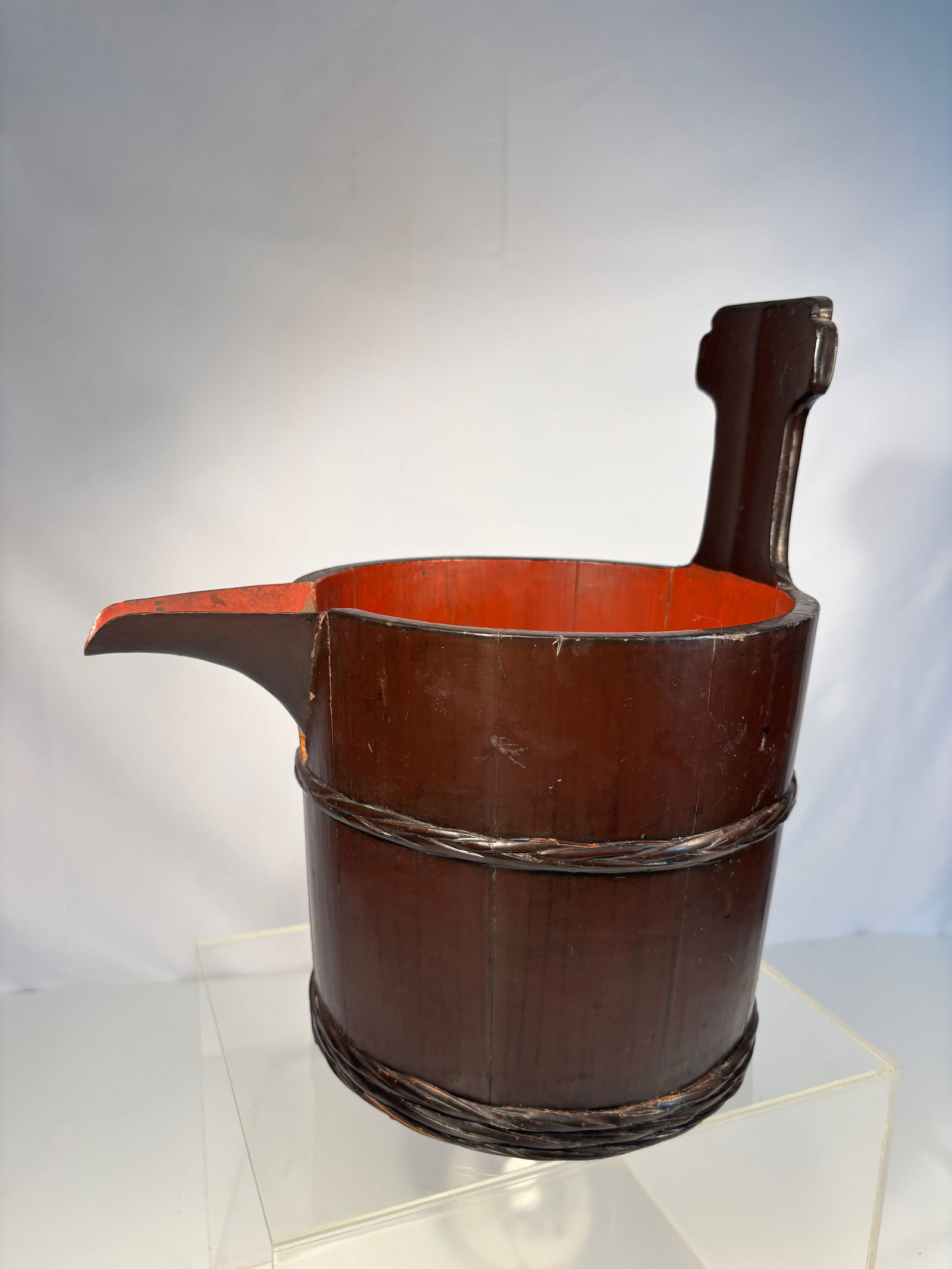 A Japanese Lacquered Bamboo Pouring Vessel with Inscription: Meiji Period (1868–1912); Of traditional coopered form, constructed from vertical bamboo staves bound with rattan strips, the cylindrical body fitted with a projecting spout and upright handle. The