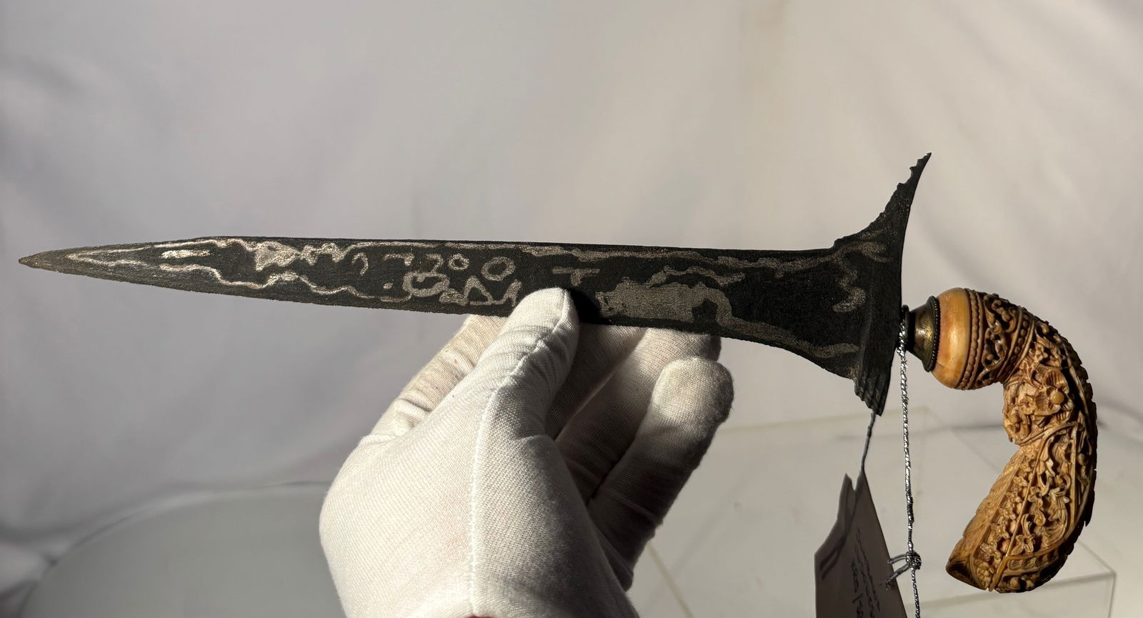 Sumbawa Indonesian Kris (Keris) Dagger with Pamor Blade and Carved Bone Hilt, Late 19th–Early 20th: An Indonesian kris (keris) dagger from Sumbawa, featuring a straight (lurus) pamor-forged blade with natural nickel–iron patterning. The blade exhibits traditional darkened patina with visible pamor