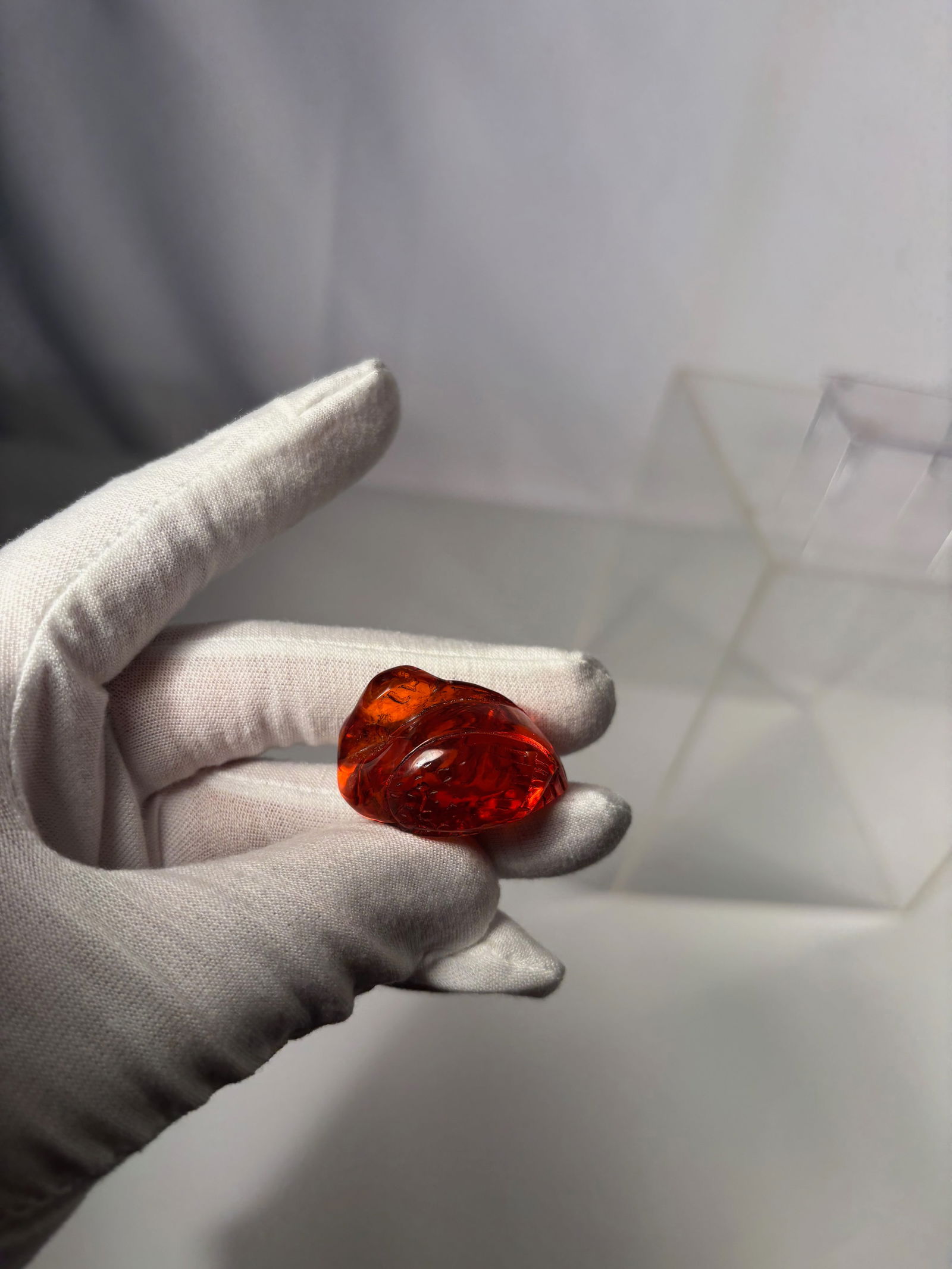 A Japanese Carved Amber Figural Ornament, Signed (Matsuyama): Meiji period (1644-1912);A finely carved Japanese amber ornament, signed (Matsuyama), likely late Meiji to Taish? period. The translucent amber of rich reddish-orange tone is skillfully worked in the