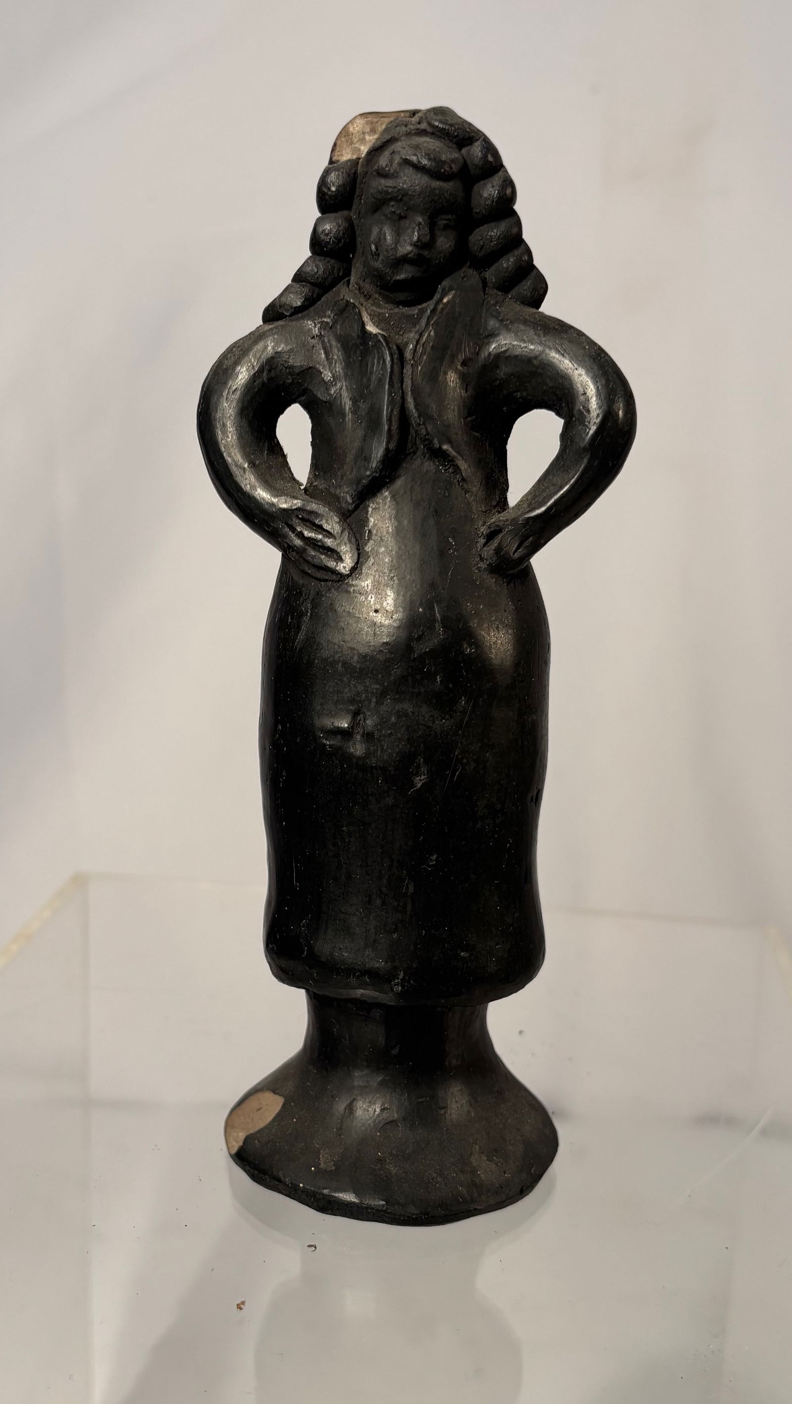 Folk Art Black Terracotta Dancing girl Figurine: Handmade black terracotta folk-art figurine, likely produced in the mid-20th century. The figure depicts a stylized woman with hands on hips, featuring exaggerated braided hair and a flared base. Crea