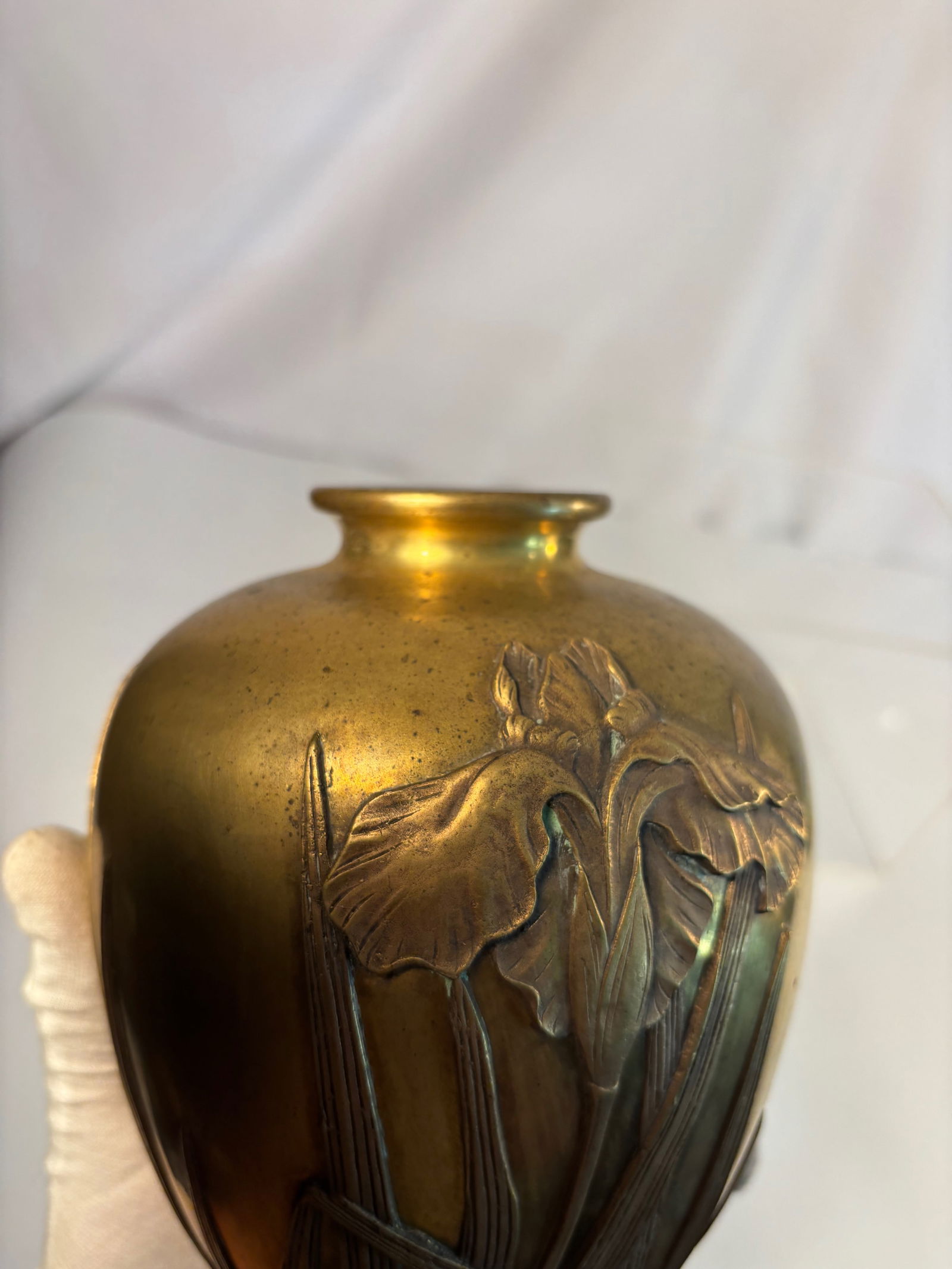 A Japanese Gilt-Bronze Vase with Irises in Relief, Signed Yoshimasa (???), Meiji to Taish: A fine Japanese gilt-bronze vase, the rounded baluster form decorated in high relief with irises and leaves in the Art Nouveau–influenced Meiji aesthetic. The petals and blades are crisply modeled w