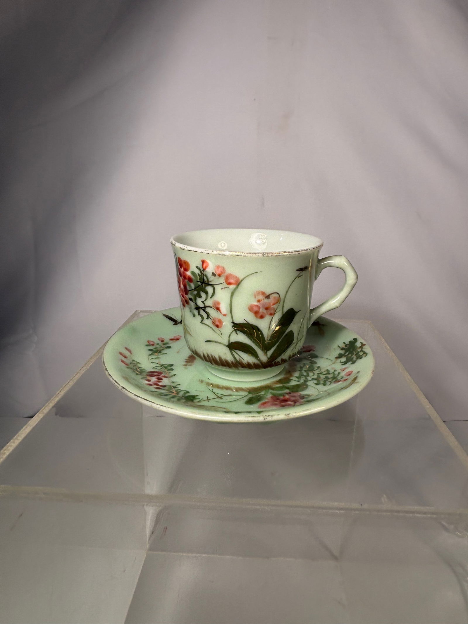 A Japanese Porcelain Cup and Saucer with Floral and Insect Decoration, Meiji Period (1868–1912) (1 of 12)