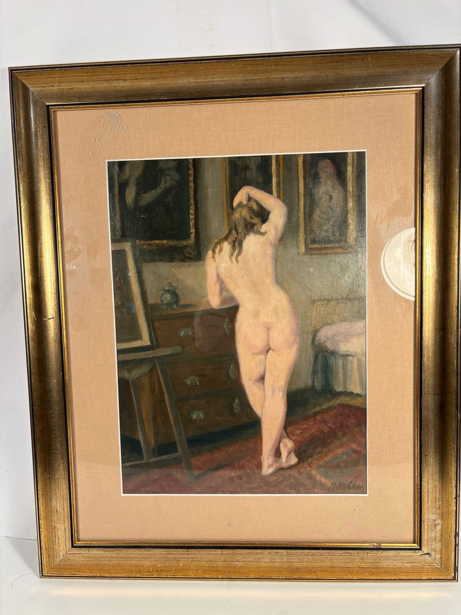 Karel Skála (Czech-American, 1908–2001), “Nude Standing II,?? Oil on Board: Oil on board depicting a standing nude female figure viewed from behind in a softly lit artist’s studio interior. Warm ochre and rose tones emphasize the model’s form against a backdrop of framed