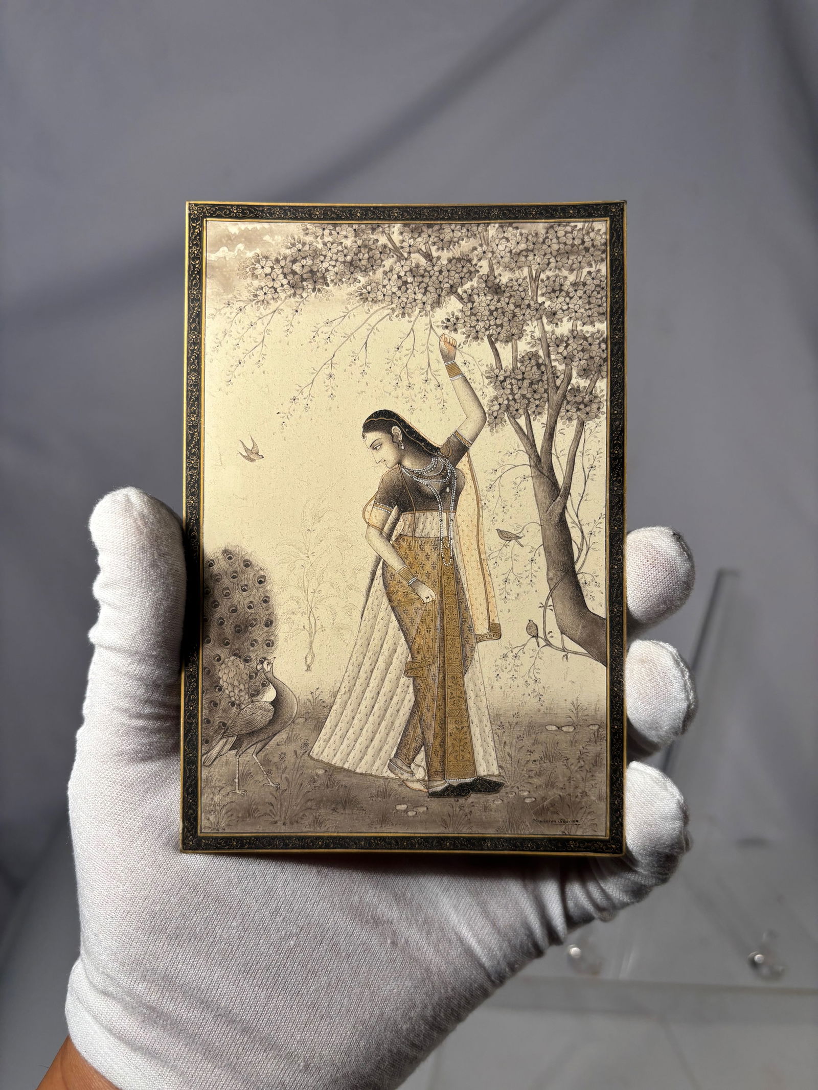 Indian Lady Under a Tree Miniature Painting, Hand-Painted,: Fine hand-painted Indian miniature showing a Nayika (lady) beneath a flowering tree, rendered in a soft monochrome palette with gold accents and delicate line work. Executed in opaque watercolor on a