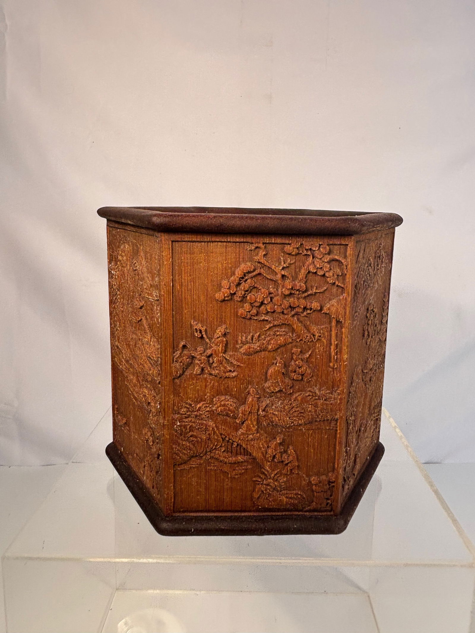 A Chinese Carved Bamboo Hexagonal Brush Pot, Late Qing/Republic Period: A Chinese hexagonal bamboo brush pot (bitong), each of the six panels finely carved in relief with landscape scenes including scholars, pavilions, pine, and a pagoda. The panels joined to form a hexag