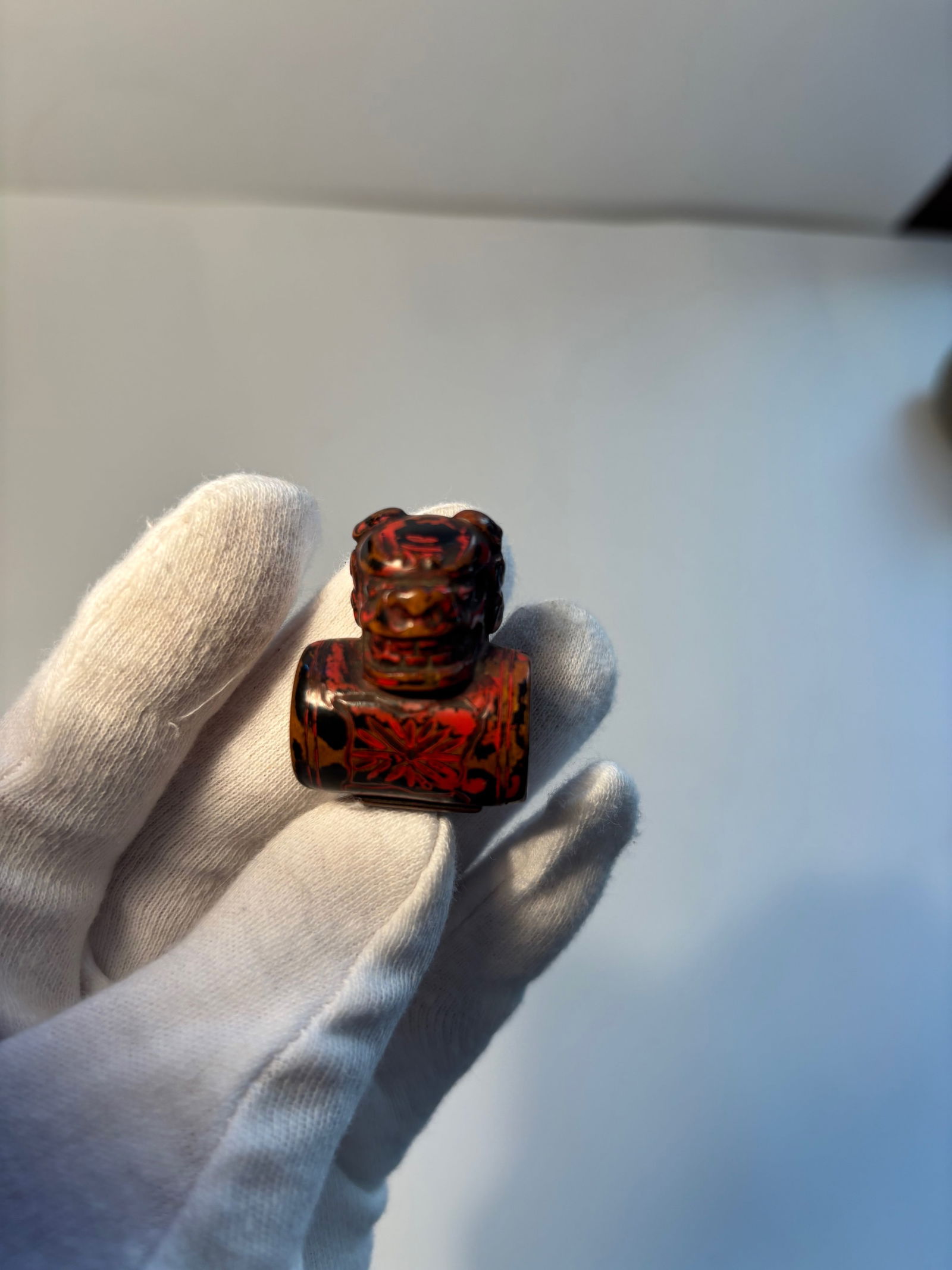 A Japanese laquered boxwood lion face carved netsuke: Edo period (1603-1868); The property of a Private Collector. Dimensions? Height: 3.5cm (1 3/8in).