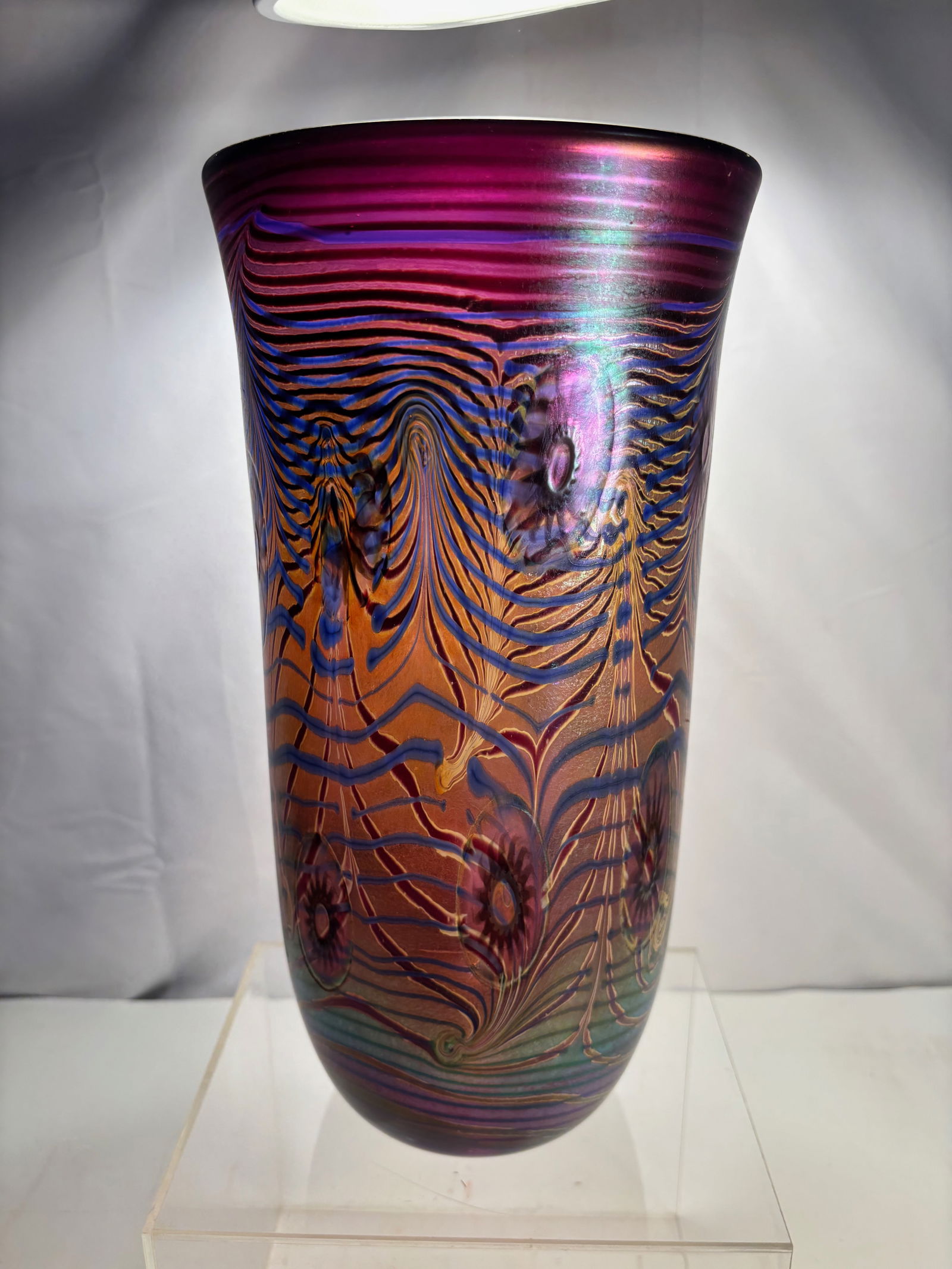A Large D. Tate Signed Studio Art Glass Vase: Studio art glass vase of tall tapering form, The vase is executed in richly colored glass with an iridescent surface and finely combed, feathered linear decoration throughout the body. The decoration