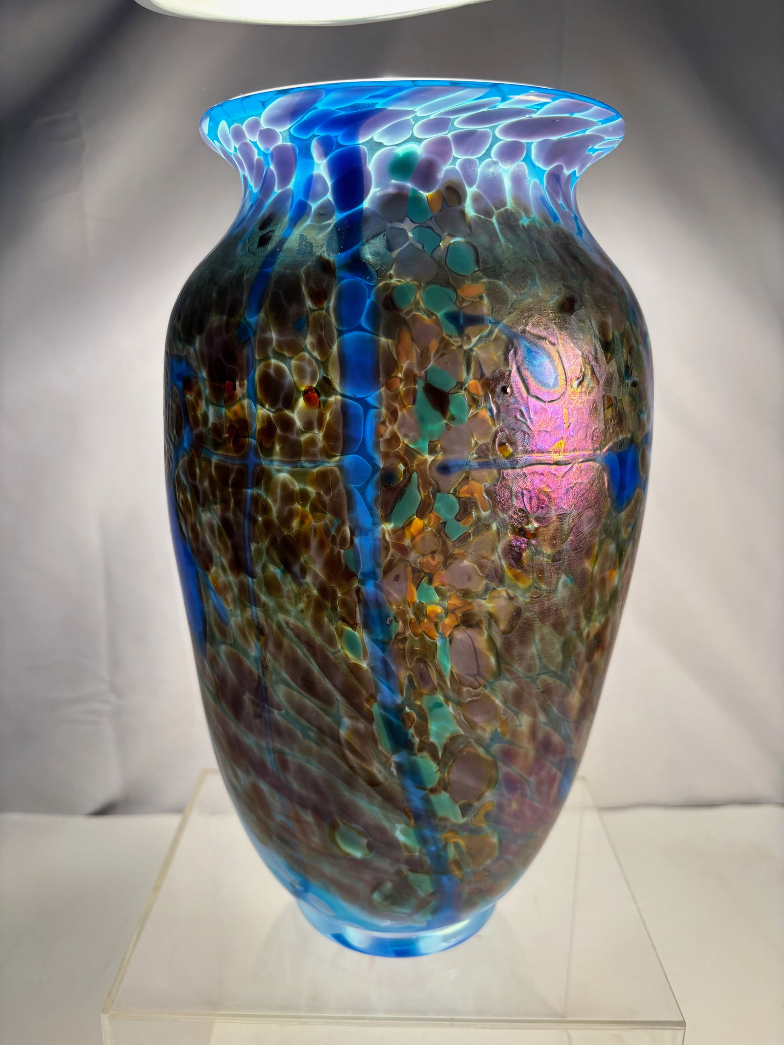 A Signed D. Tate Iridescent Art Glass Vase, 1994: Hand-blown studio art glass vase of tall ovoid form with a gently flared rim. The vase is executed in richly iridescent glass, decorated with a complex cellular pattern and flowing vertical cobalt-blu