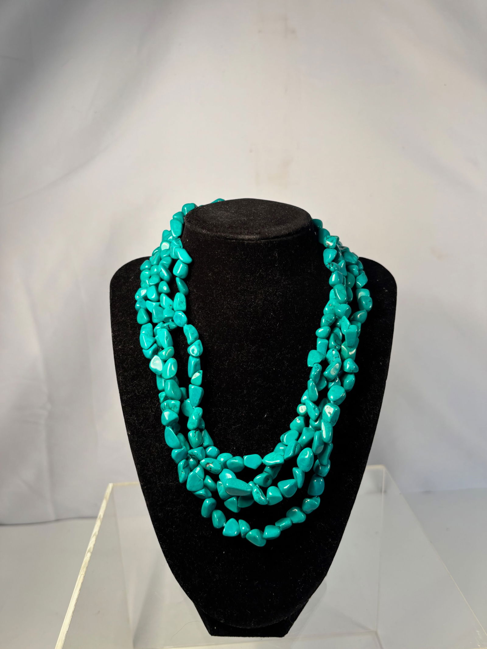 A Four-Strand Turquoise Chip Bead Necklace, 18 Inches, 134 g: A bold vintage four-strand necklace composed of polished turquoise-color chip beads, likely dyed howlite or reconstituted turquoise, strung in multiple twisted strands with a silvertone adjustable cha
