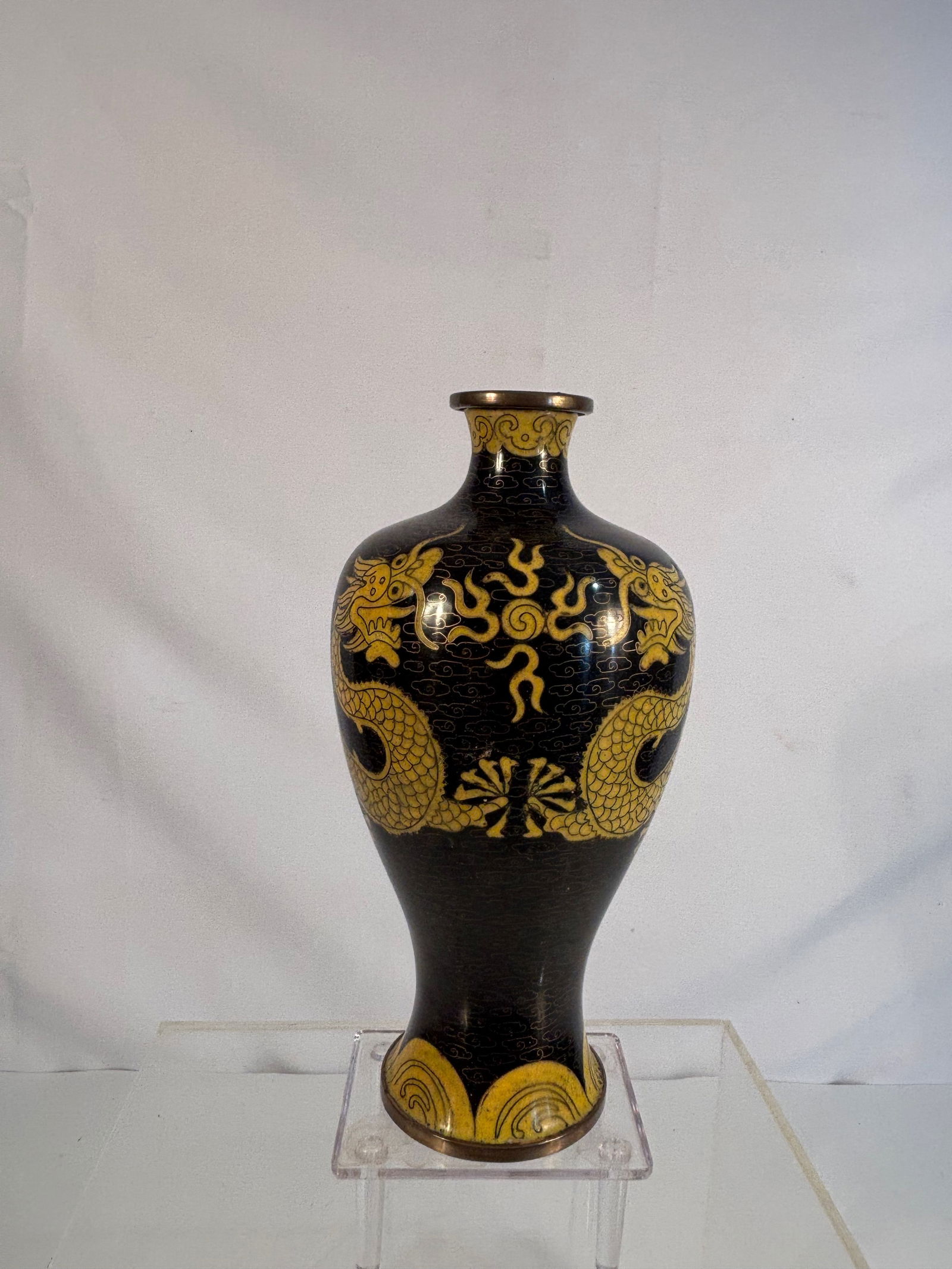 A Chinese Cloisonné Vase with Yellow Dragons on Black Ground, Late 19th Century: A Chinese cloisonné enamel vase, The baluster form decorated with a pair of five-clawed yellow dragons in pursuit of flaming pearls amidst stylized clouds, all reserved on a rich black enamel ground.