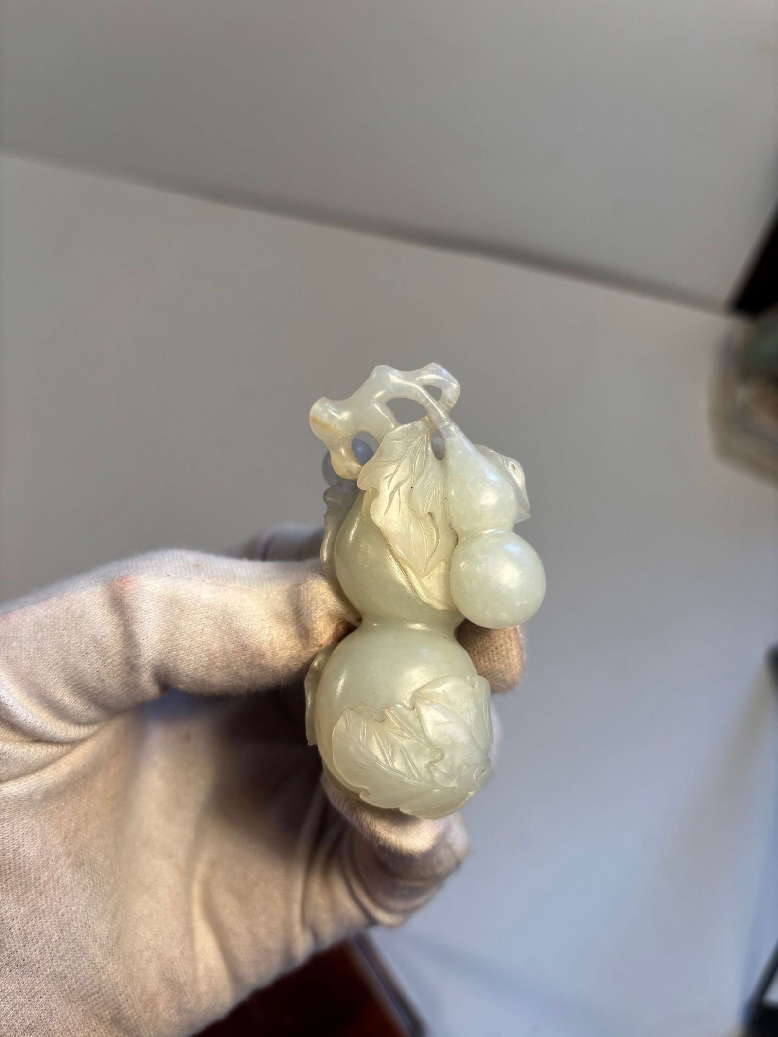A Chinese white nephrite jade carving of guard: Qing Dynasty (1644-1912),The object is carved in the form of double gourds with leaves and vines; Dimensions?Height: 7 cm