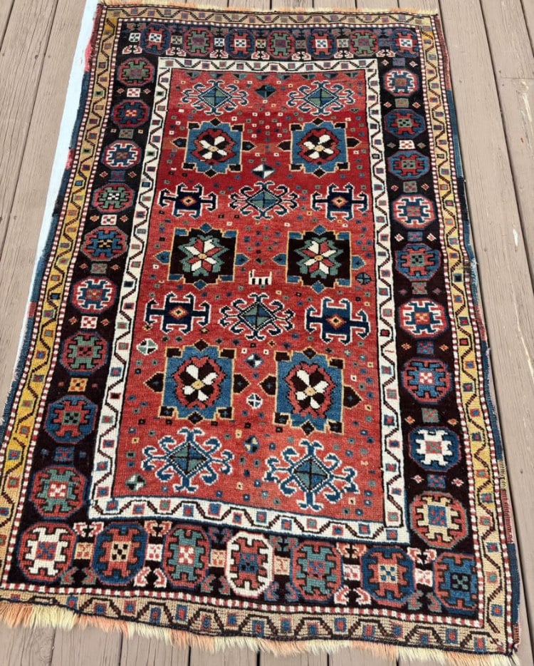 Antique Caucasian Kazak hand knotted 100% wool Rug: Bold geometric medallions in rich colours like red, blue, green, and ivory.Hooked motifs and ram’s horn symbols.Dimensions? 6 feet 3 inches x 3 feet 10 inches .