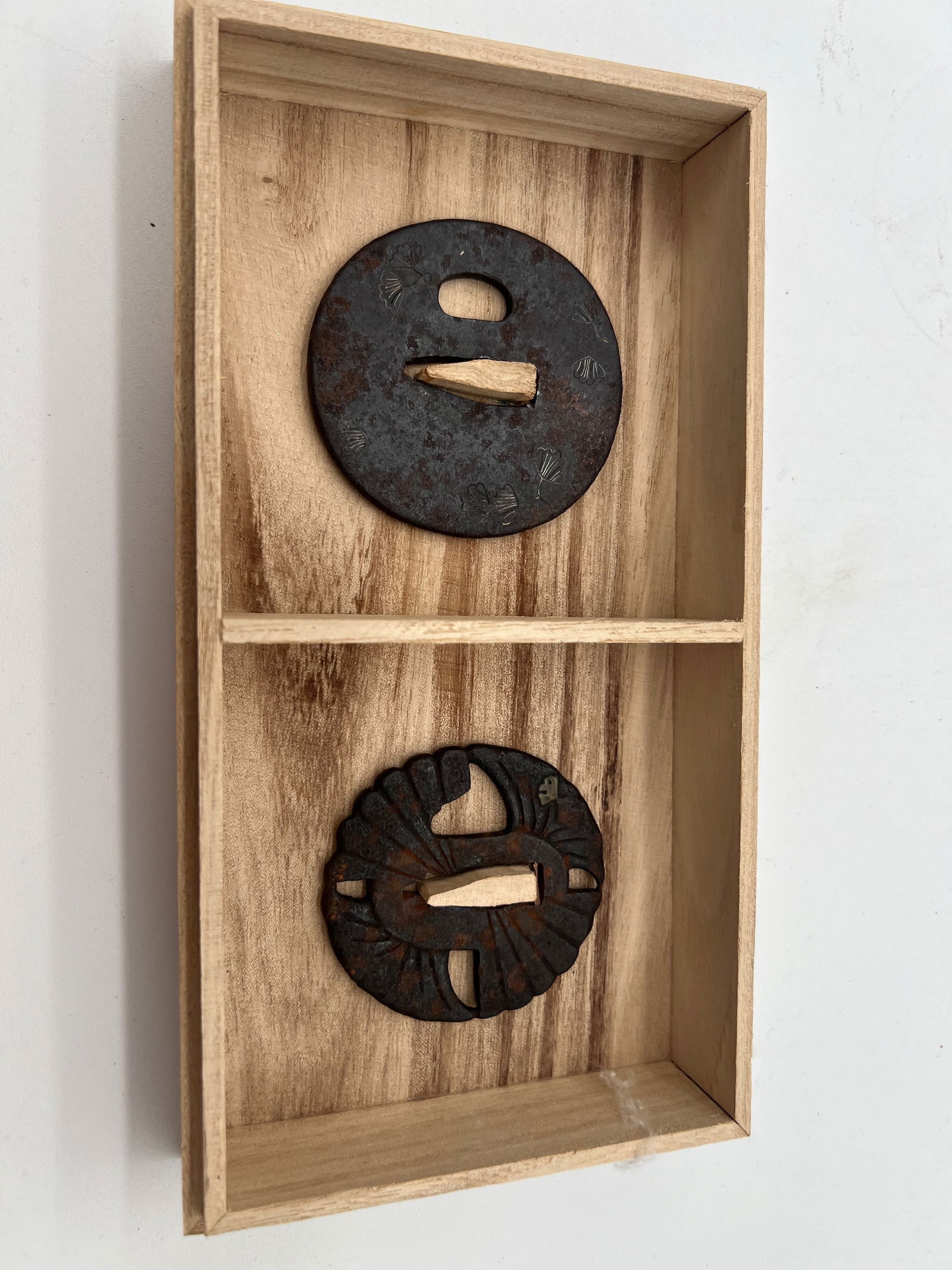 A set of two Iron Gold Inlay Tsubas Edo Period (1603-1868): One Tsuba Displays a more dynamic and openwork design, possibly mimicking waves or a crest motif. Another one Features engraved ginkgo leaf designs, which symbolize longevity and resilience in Japanes