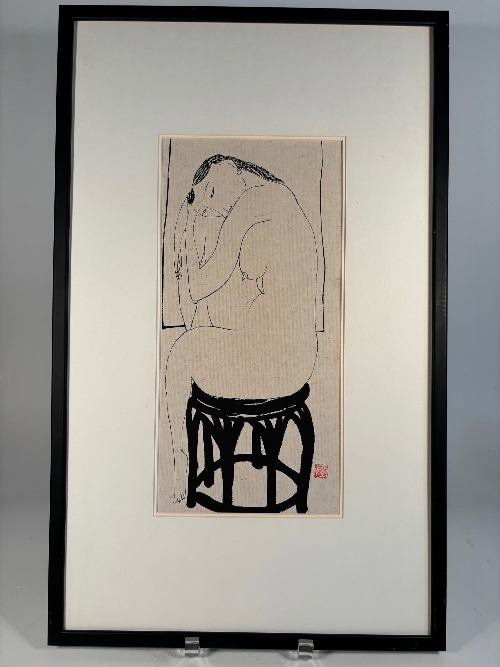 A Chinese Ink Painting of a Seated Nude Woman with Seal Mark "LU": Ink on paper, depicting a nude female figure seated in profile on an openwork Chinese stool. The stylized lines are bold yet minimal, capturing form and emotion with expressive economy. A red seal mar