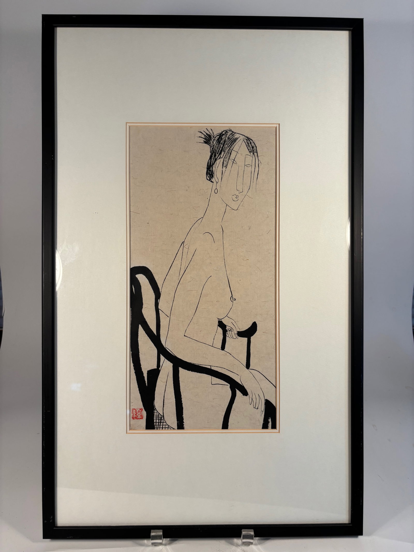A Chinese Ink Painting of a Seated Nude Woman with Seal Mark "LU": Ink painting on paper depicting a stylized nude woman seated in a Ming-style armchair. Executed in elegant linear brushwork with minimal detail, the composition emphasizes form and posture. A red arti