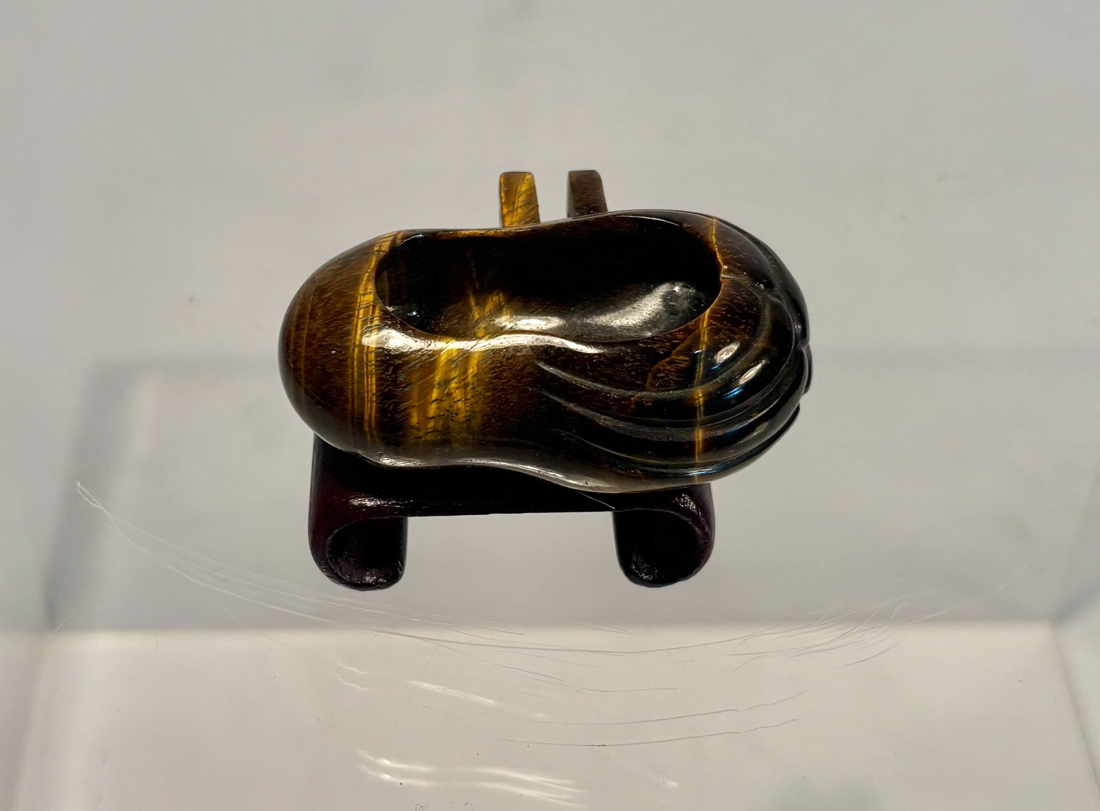 A Carved Tiger’s Eye Bird Feed Cup, Miniature Feeder: A finely carved tiger’s eye bird feed cup, traditionally used as a food or water holder for small songbirds. Fashioned from richly banded tiger’s eye stone, the piece displays beautiful natural ch