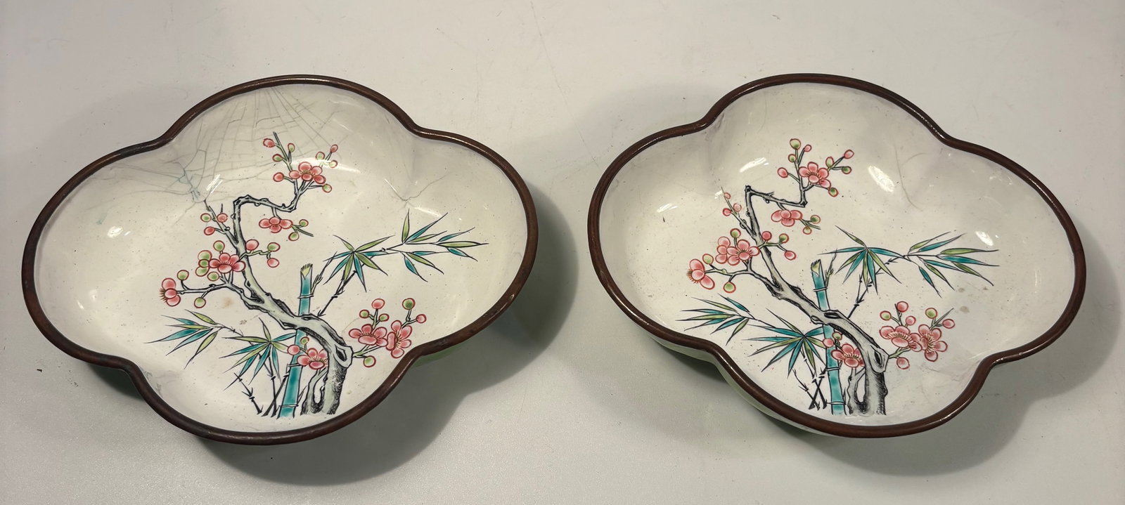 Pair of Chinese Copper Enamel Lobed Dishes with Polychrome Decoration: 19th century, A pair of Chinese copper enamel lobed dishes, each of clover-shaped form, decorated with hand-painted polychrome enamel floral and bamboo motifs against a light ground. The reverse finis