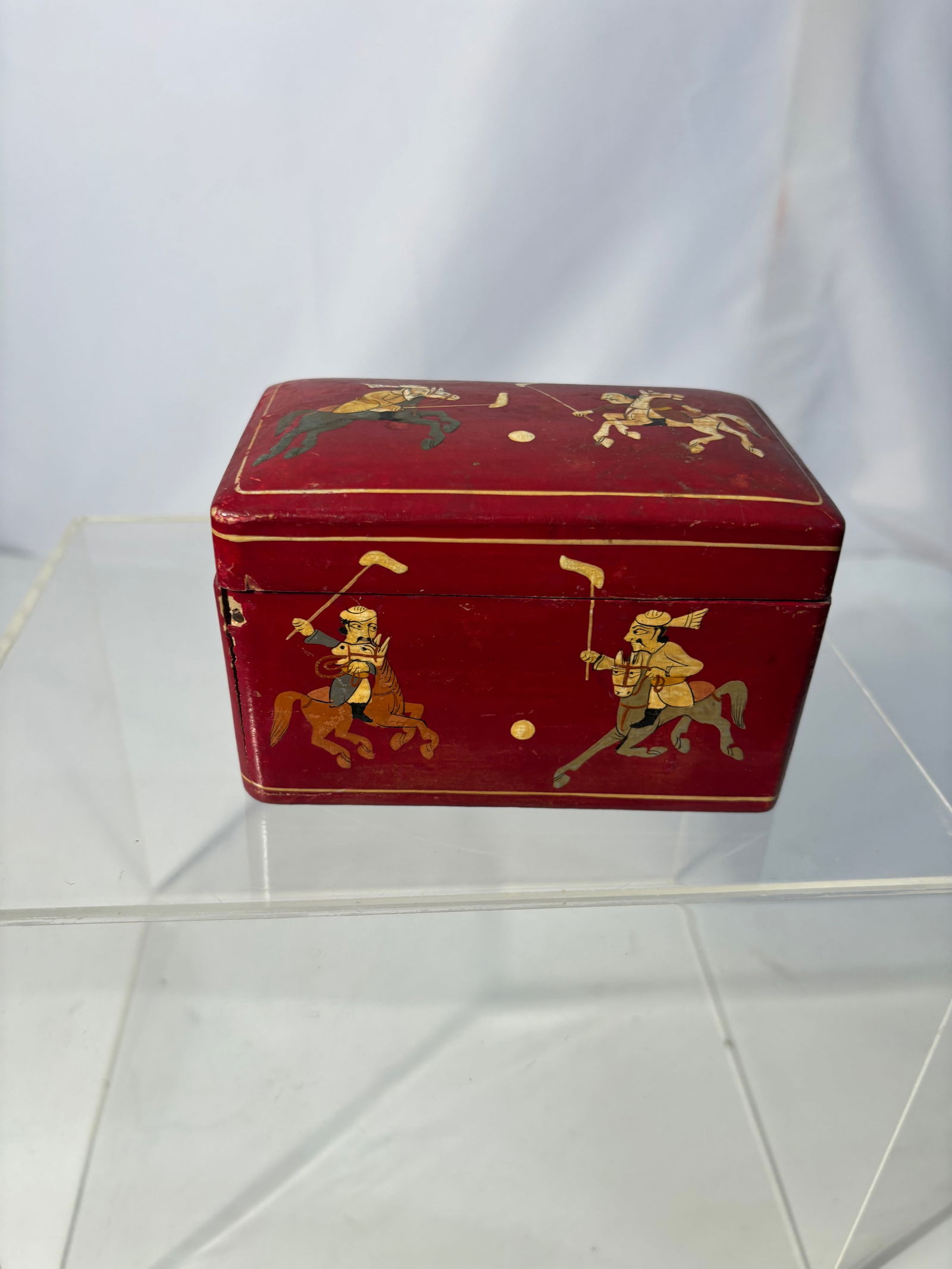 Indian Lacquered Box with Polo Scene, Mughal-Style Decoration: Rectangular Indian lacquered box decorated on all sides with mounted polo players in the traditional Mughal / Rajasthani miniature style. The figures are shown in dynamic motion, wielding polo mallets