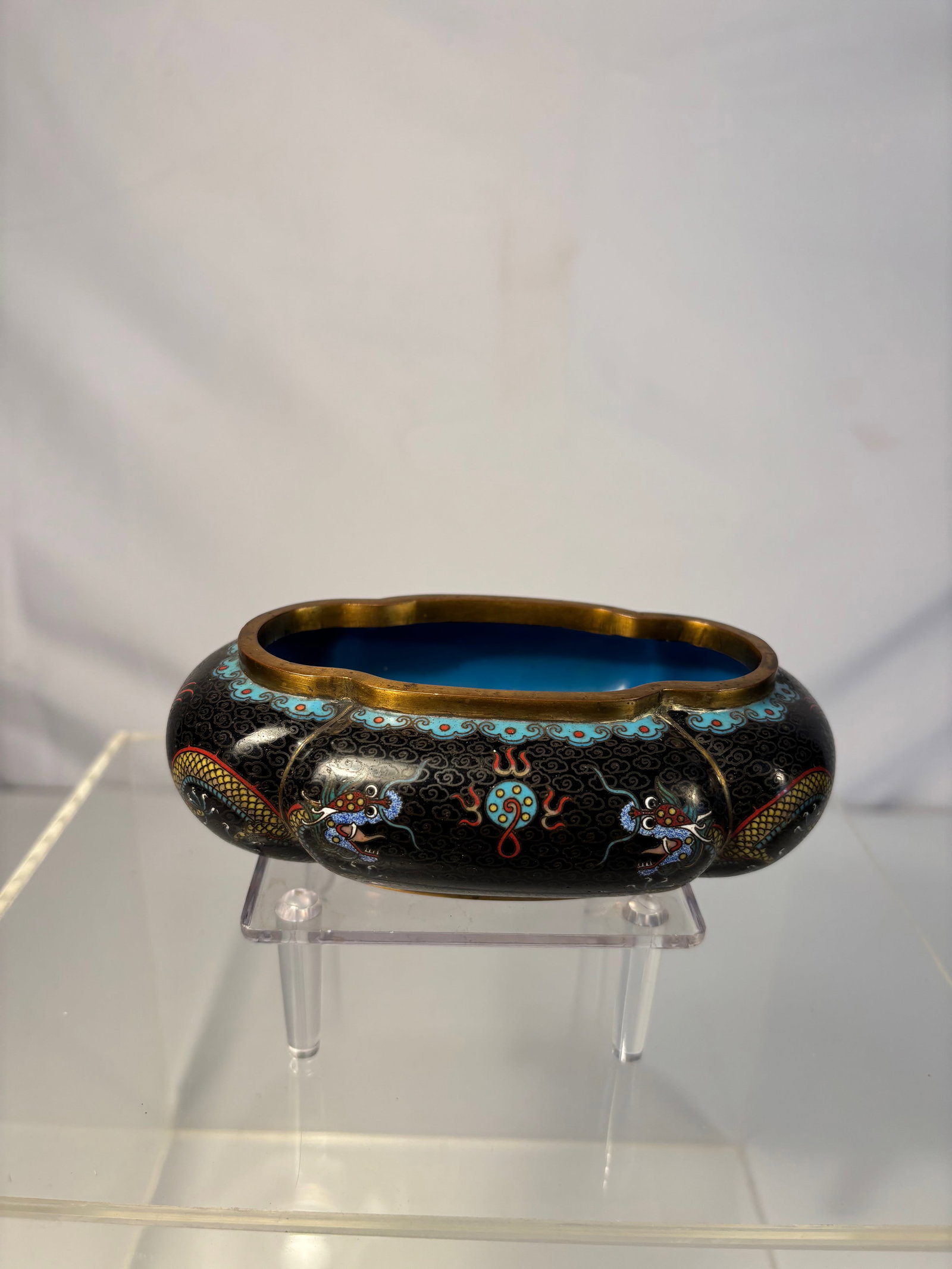 A Chinese Cloisonné Enamel Water Pot with Dragons: Qing Dynasty(1644-1912); A Chinese cloisonné enamel water pot with scalloped rim, decorated on a black ground with colorful five-clawed dragons in pursuit of flaming pearls amid clouds and fire scrol