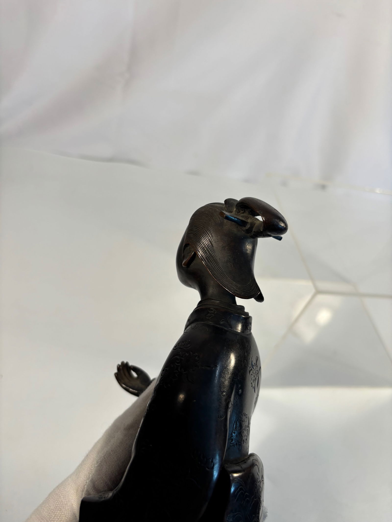 A Japanese-Style Bronze Figure of a Young Woman in Kimono, Meiji period: Meiji period (1868-1912); A fine Meiji period Japanese bronze figure depicting a young woman dressed in a traditional kimono, standing gracefully with her head slightly tilted and holding her garment