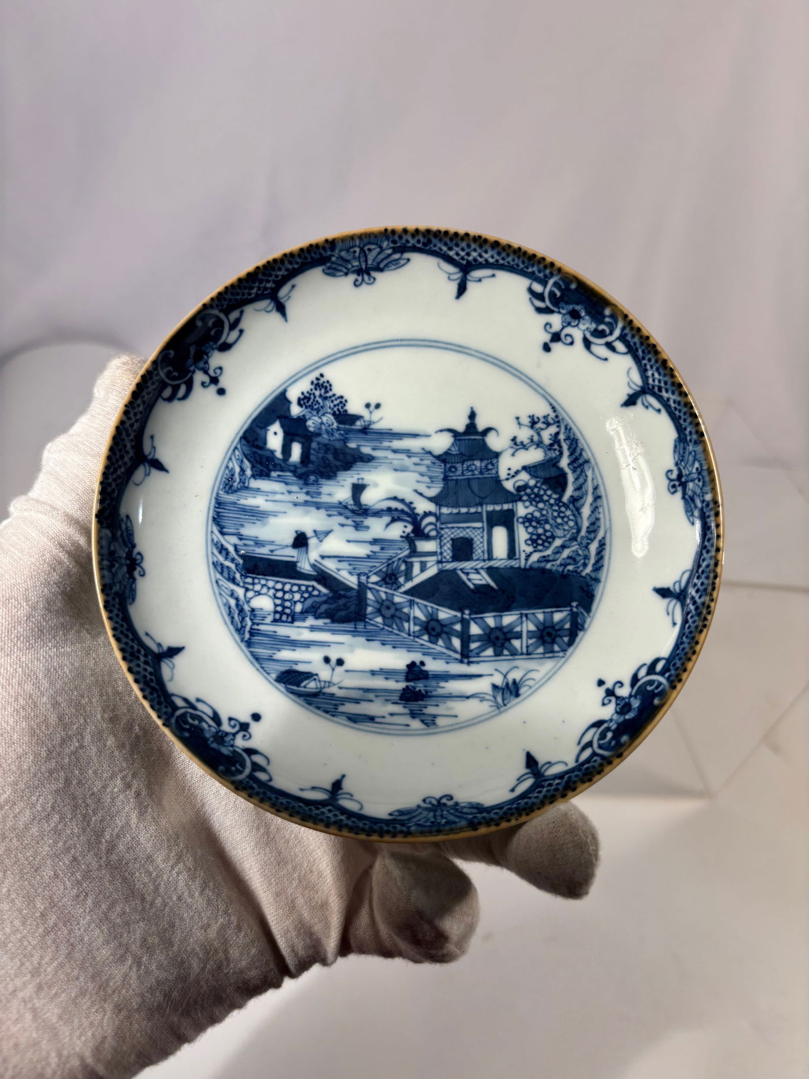 A Chinese Blue and White Porcelain Dish, Qianlong Period (1736–1795): Qianlong period (1736–1795); A finely potted Chinese blue and white porcelain dish, Qianlong period (1736–1795), decorated in underglaze cobalt blue with a riverside landscape scene depicting pavi