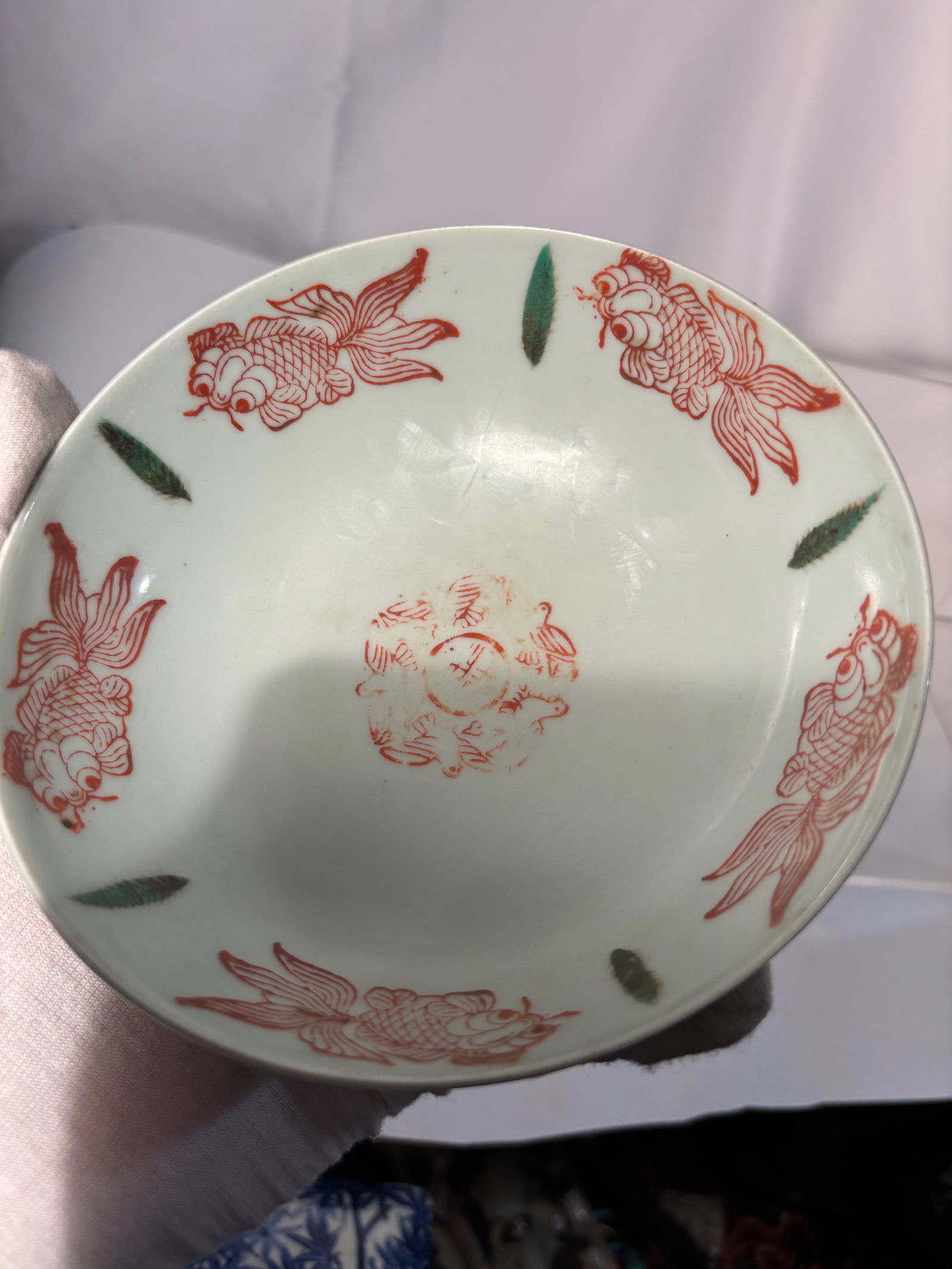 A Chinese Famille-Verte Porcelain Bowl with Iron-Red Fish: Qing dynasty(1644-1912); Probably kangxi period ; Delicately potted with gently flared sides rising from a short circular foot, the bowl is finely decorated in iron-red and translucent green enamels.