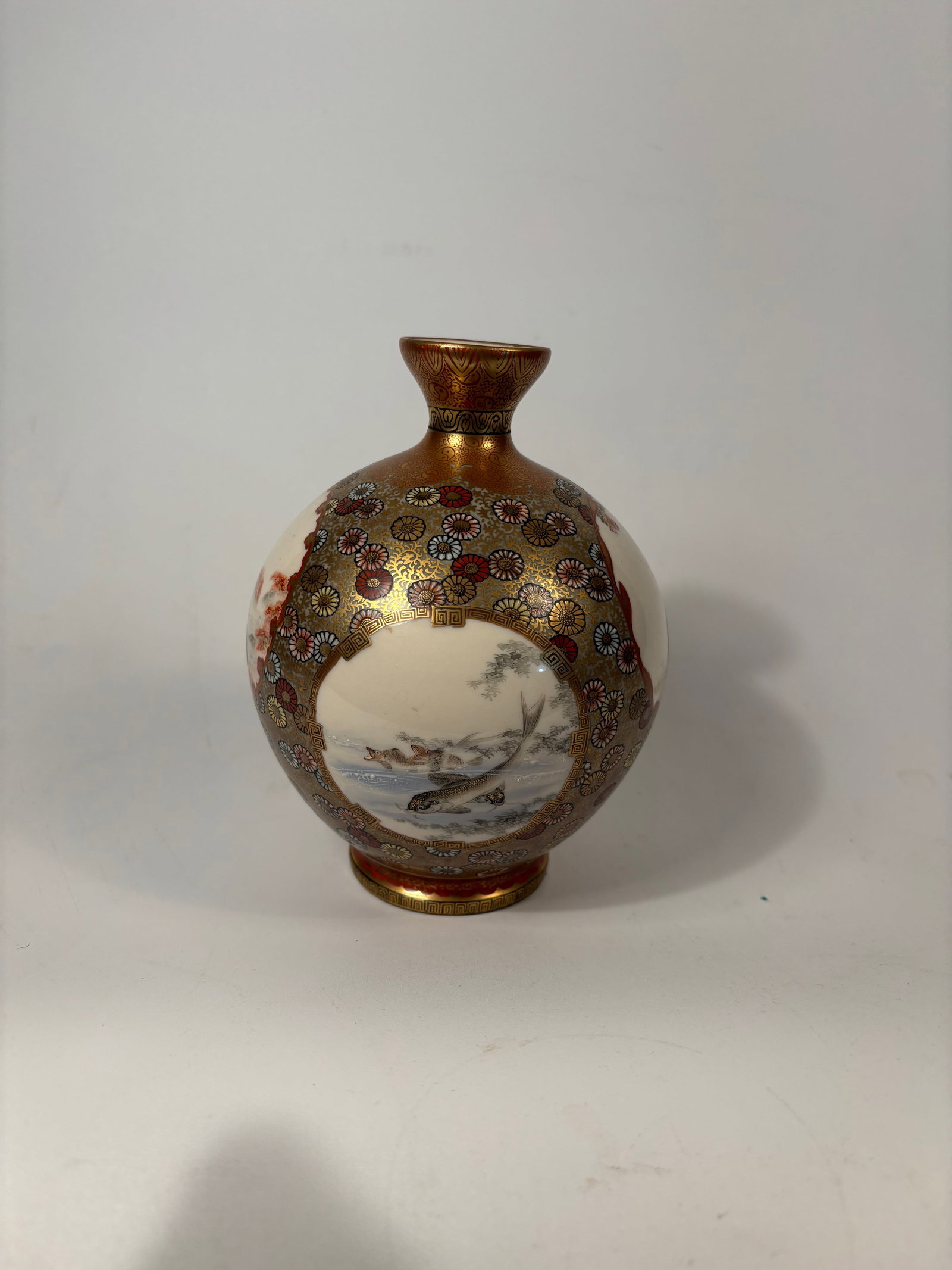 A Japanese Bunraku-style Satsuma porcelain vase with mark: late Meiji (c. 1890–1912) to early Taish? period (c. 1912–1926).The vase shows finely detailed hand-painted panels with traditional Japanese figures, nature scenes, and symbolic motifs like koi, b