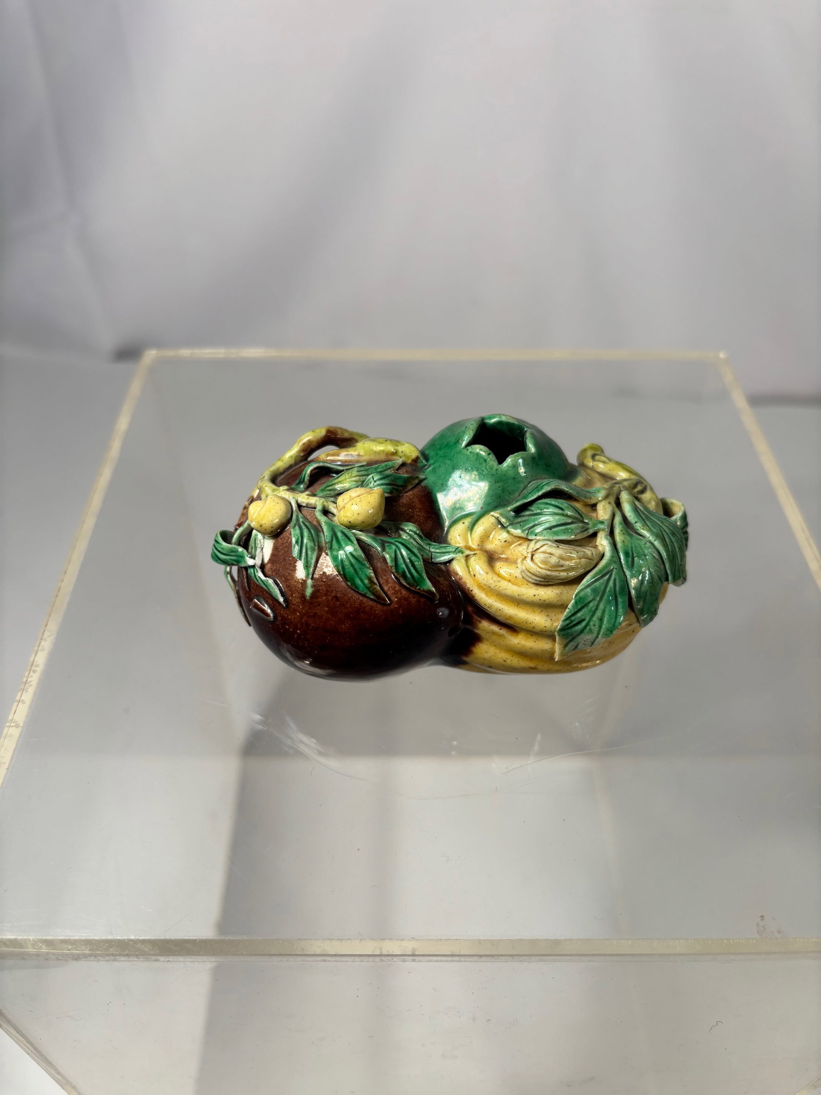 A Chinese porcelain Glazed Fruit-Form Water Dropper with mark: Kangxi period (1662–1722),A Chinese Su Sancai (plain three-color) glazed water dropper, fruit-form, Kangxi period (1662–1722). The hollow-bodied vessel is modeled naturalistically as a fruit and f