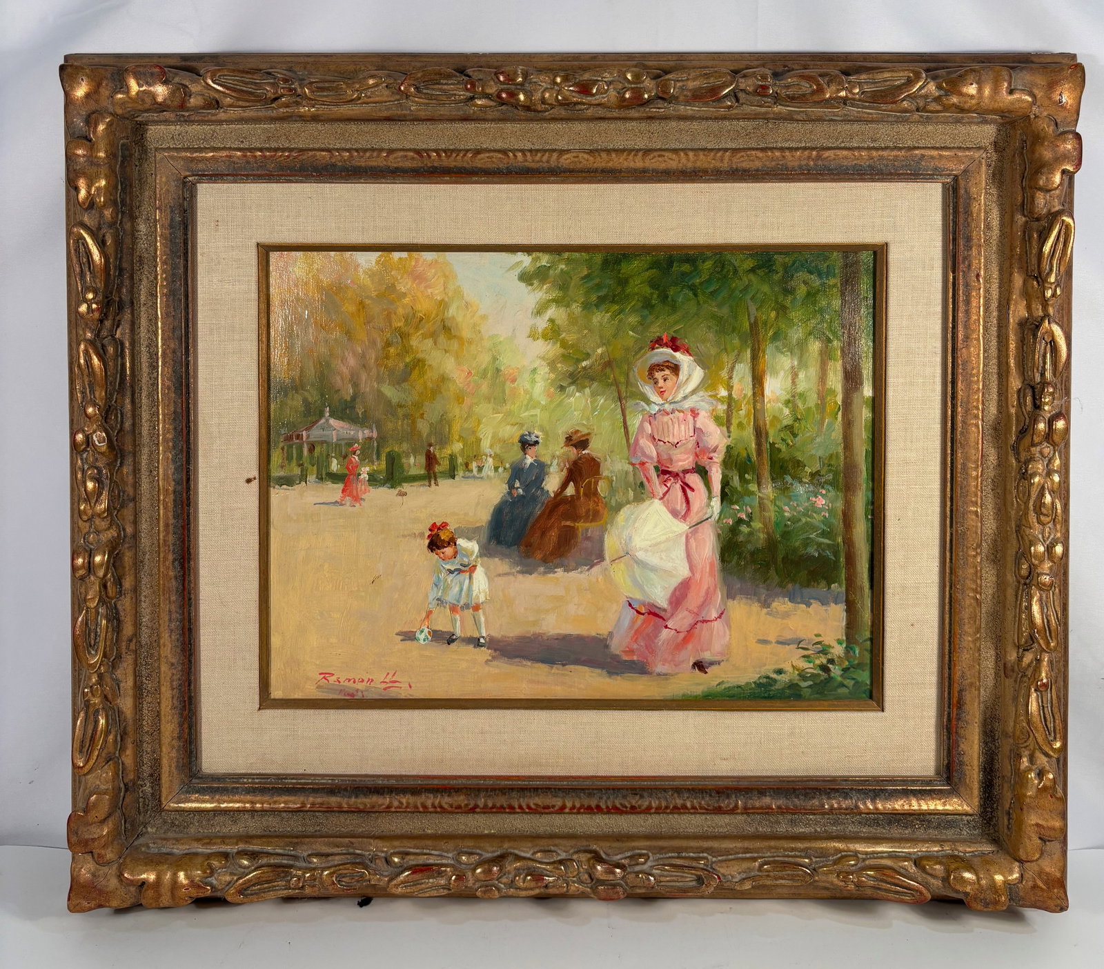 Luis Ramon (French, mid-20th century) “Promenade in the Park, Paris?? – Oil on Canvas: Charming oil on canvas depicting a Belle Époque park scene with elegantly dressed figures strolling under leafy trees. Signed lower left Luis Ramon, Paris. Presented in its original ornate giltwood