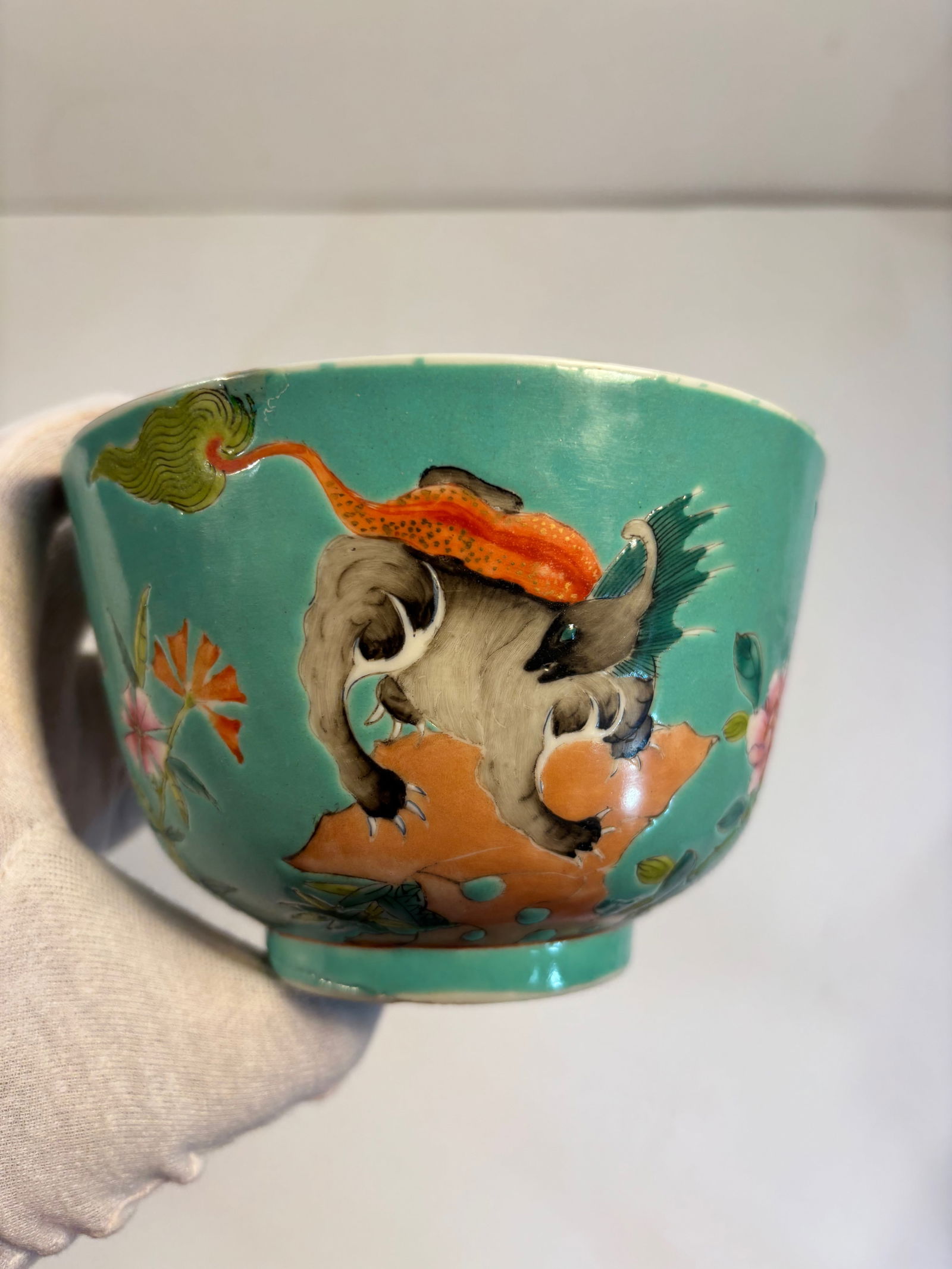 A Chinese famille rose turquoise ground porcelain bowl with "JIAQING" iron red mark: Late 19th to early 20th, features guardian lions (foo dogs) or mythical qilins .Dimensions? Diameter: 5.25 inches ; Height: 3.25 inches.