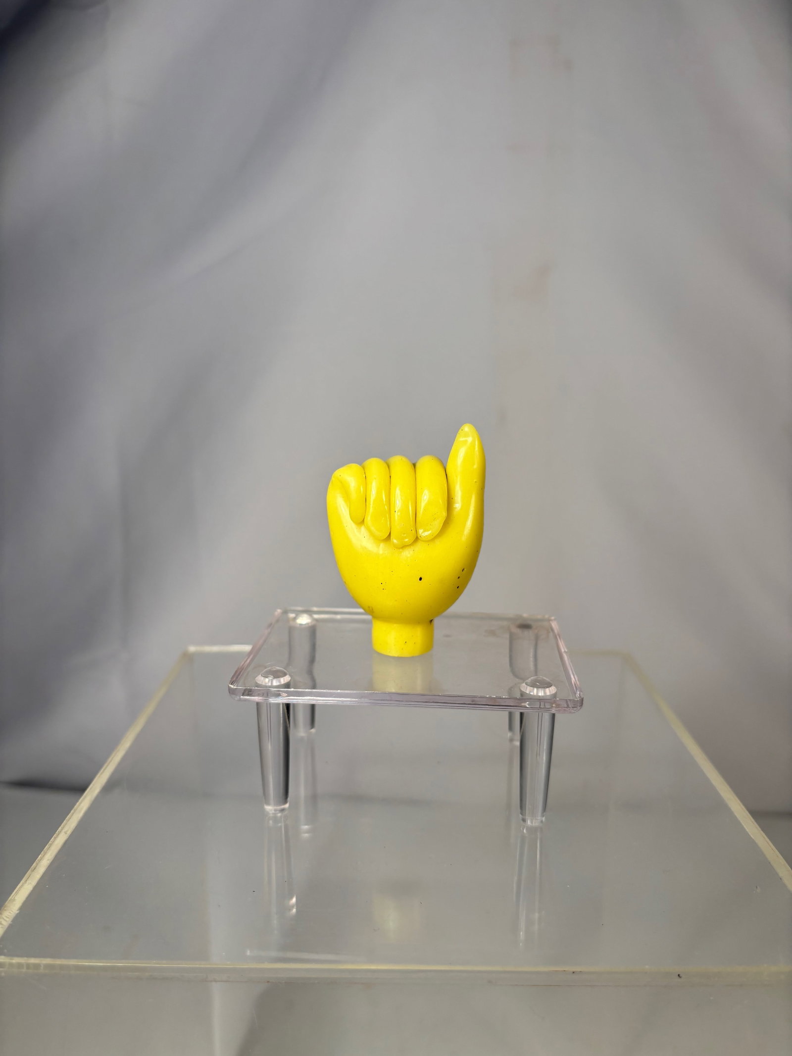 A Rare Chinese Yellow Glass Figural Hand-Form Snuff Bottle: Qing Dynasty (1644-1912); A Chinese yellow glass snuff bottle carved in the form of a stylized hand with the index finger raised. The bottle is hollowed from the interior, with a circular mouth at