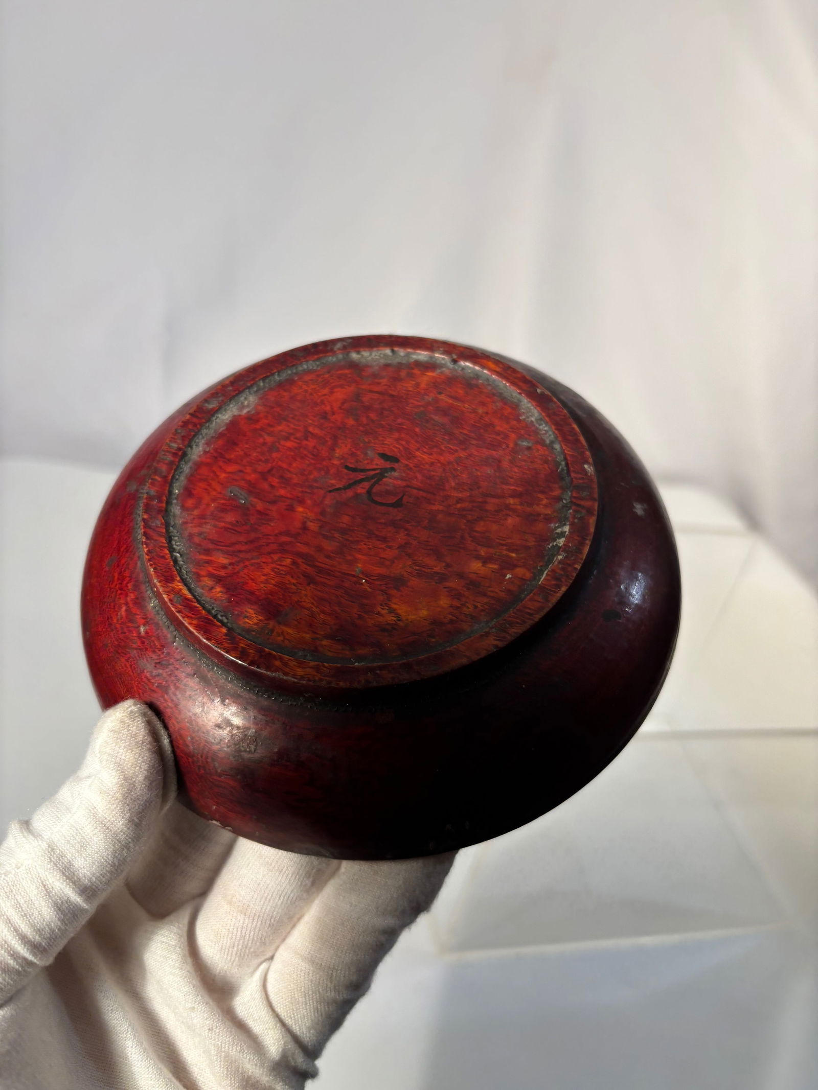 A Japanese Red Lacquer Wooden Bowl with “Gen?? (?) Mark, Edo–Meiji Period: A fine Japanese wooden lacquer bowl (wan) coated with layers of rich vermilion red urushi lacquer. The surface shows beautiful natural age wear, revealing areas of the underlying wood and darker lacqu