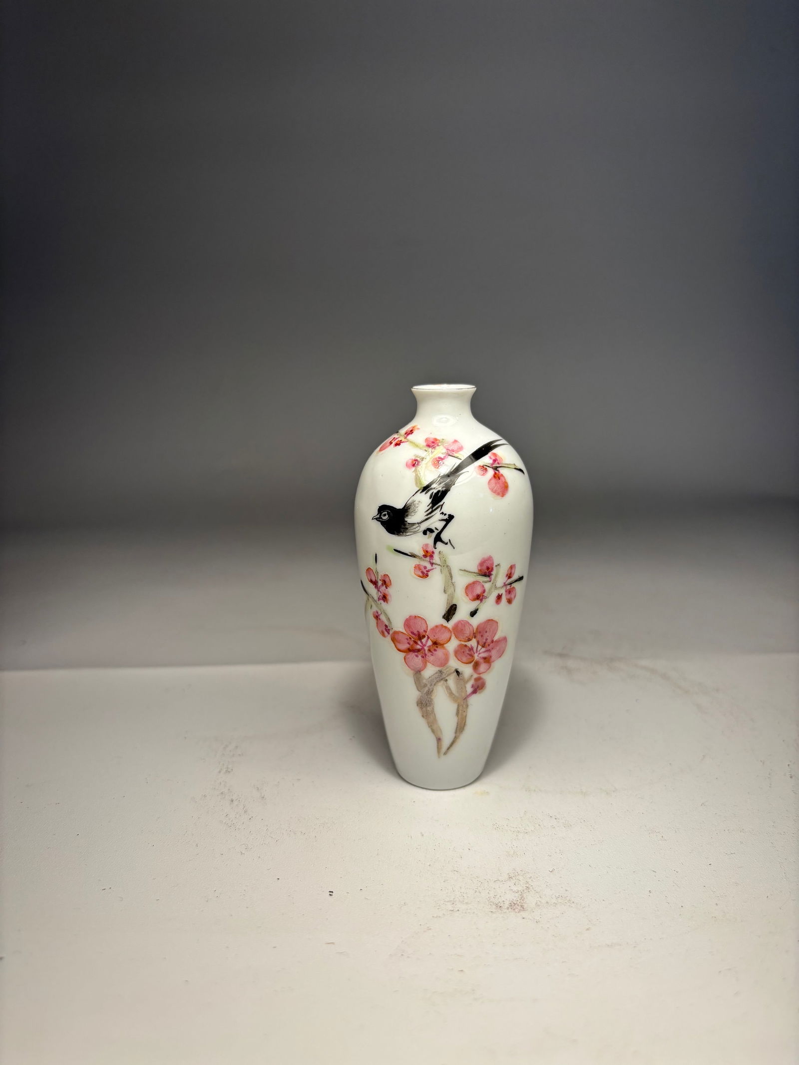 A Chinese Famille Rose ‘Magpie and Plum Blossom’ Miniature Vase, JINDEZHENG Mark: Early 20th centry; A Chinese famille rose porcelain miniature vase, finely enameled with a magpie perched on a blossoming plum branch, with poetic inscription and seal mark.Dimensions? Height: 3.75 in