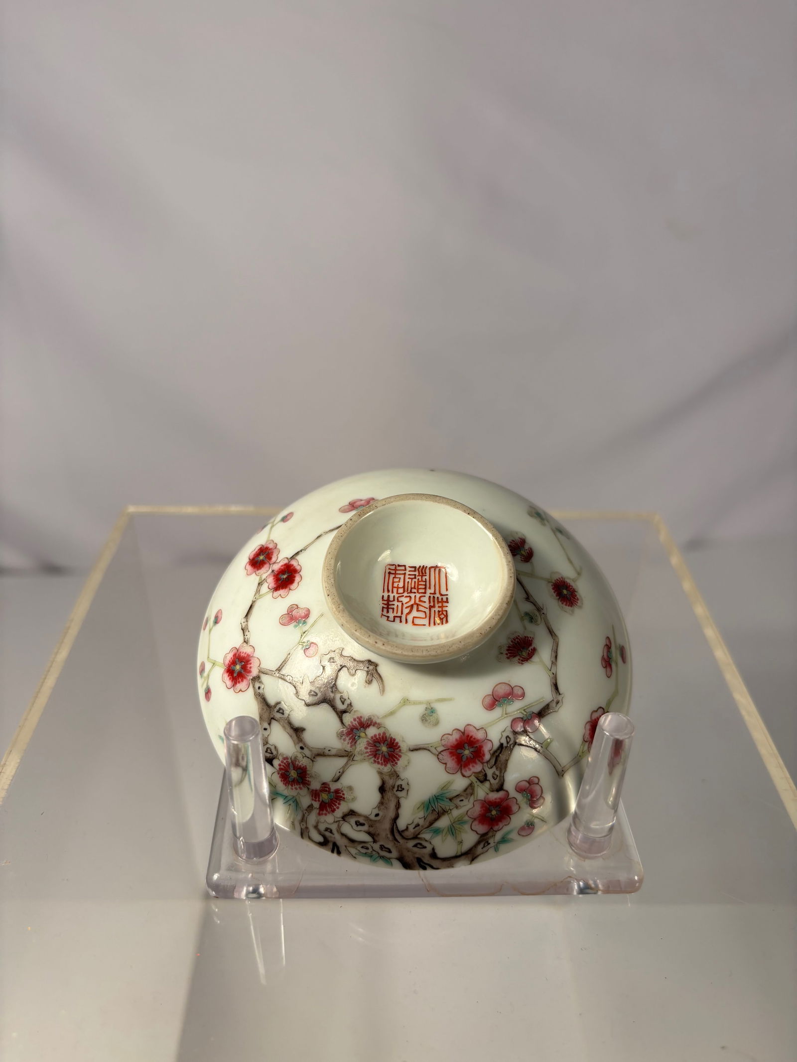 A Chinese Famille Rose Porcelain dish with Prunus Blossoms, six-character Daoguang mark: Qing dynasty(1644-1912); delicately painted in famille rose enamels with flowering prunus branches, the gnarled trunks extending around the sides and issuing buds and blossoms in red and white. The ba