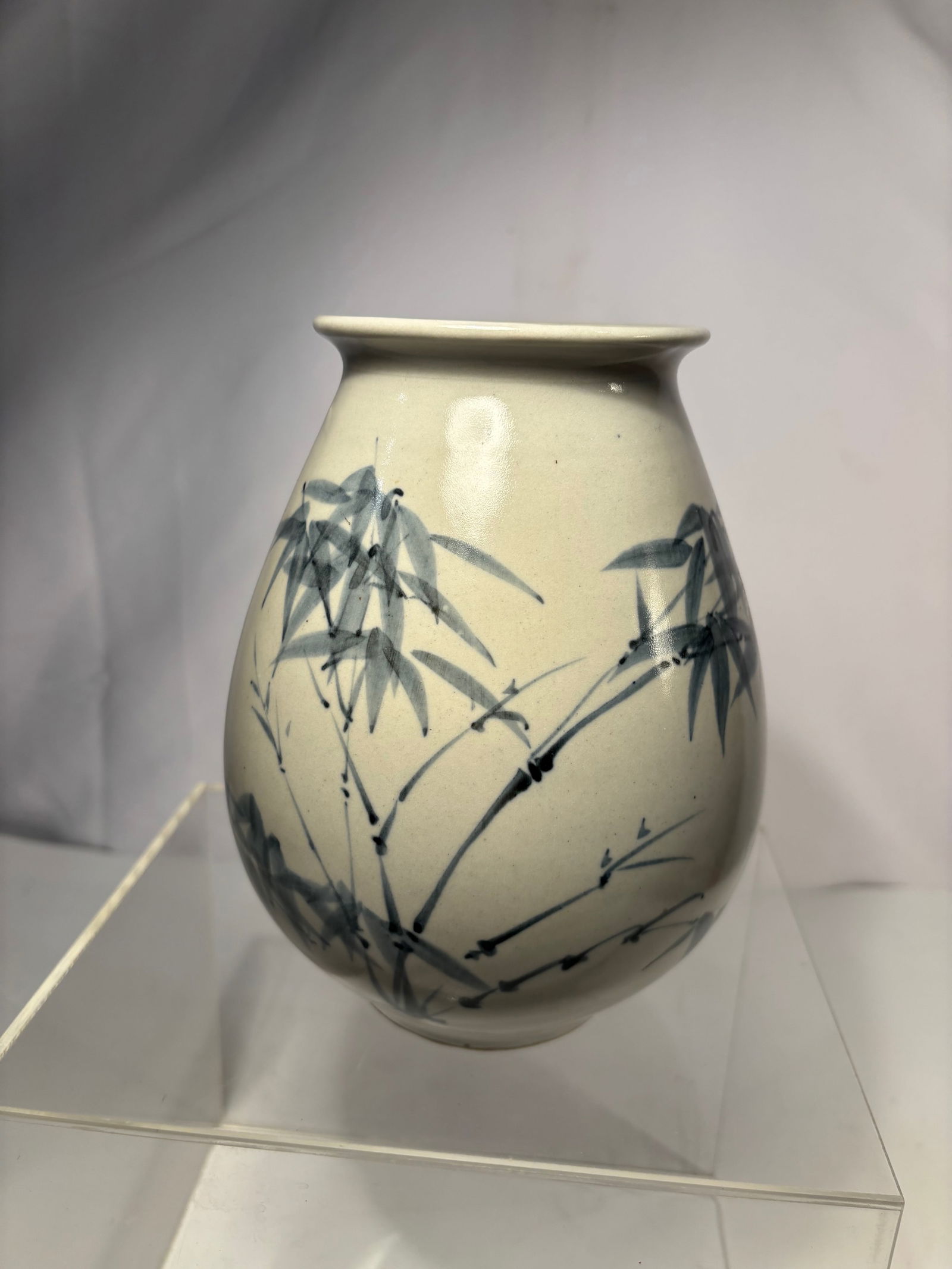 A Korean Blue-and-White Porcelain Vase with signature: A Korean blue-and-white porcelain vase with flared rim, short neck, and rounded body. The surface is finely painted in underglaze cobalt with graceful bamboo leaves, executed in flowing brushstrokes r