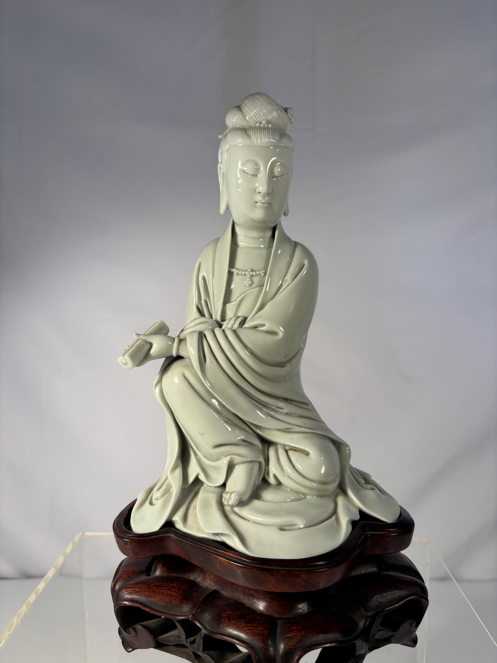 A Chinese Blanc-de-Chine Porcelain Figure of a Lady / Guanyin marked "XU CHANG FA": Qing Dynasty(1644-1912), A finely modeled Chinese blanc-de-chine porcelain figure, depicting a serene lady / Guanyin seated in flowing robes with hair arranged in a high chignon. The figure is execute