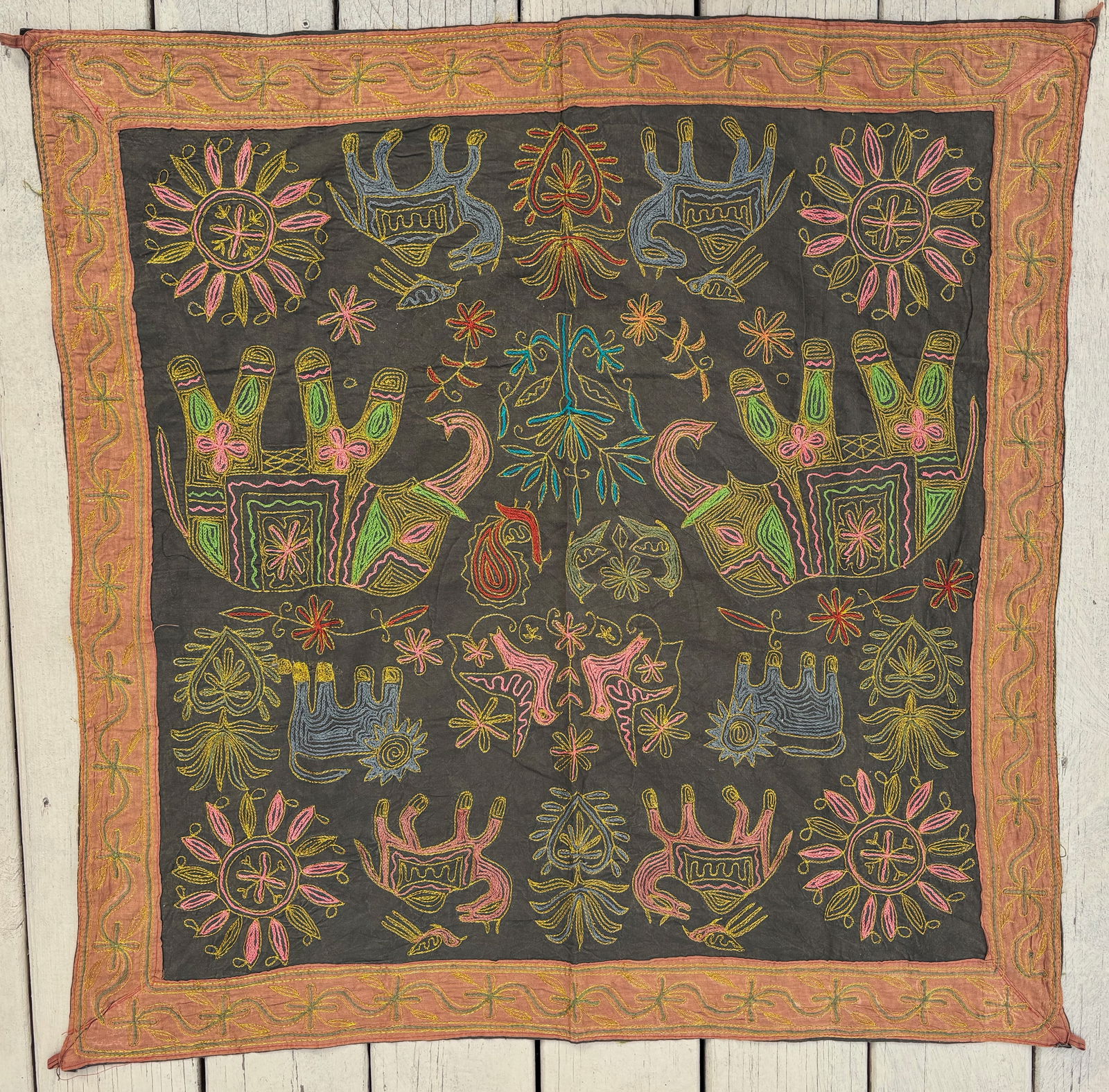 A Chinese Miao Minority Polychrome Chain-Stitch Embroidery Panel with Animal & Sun Motifs: Chinese Miao minority embroidered textile panel, likely 20th century. Executed in vibrant polychrome threads on a dark indigo ground, the decoration worked predominantly in chain stitch. The compositi