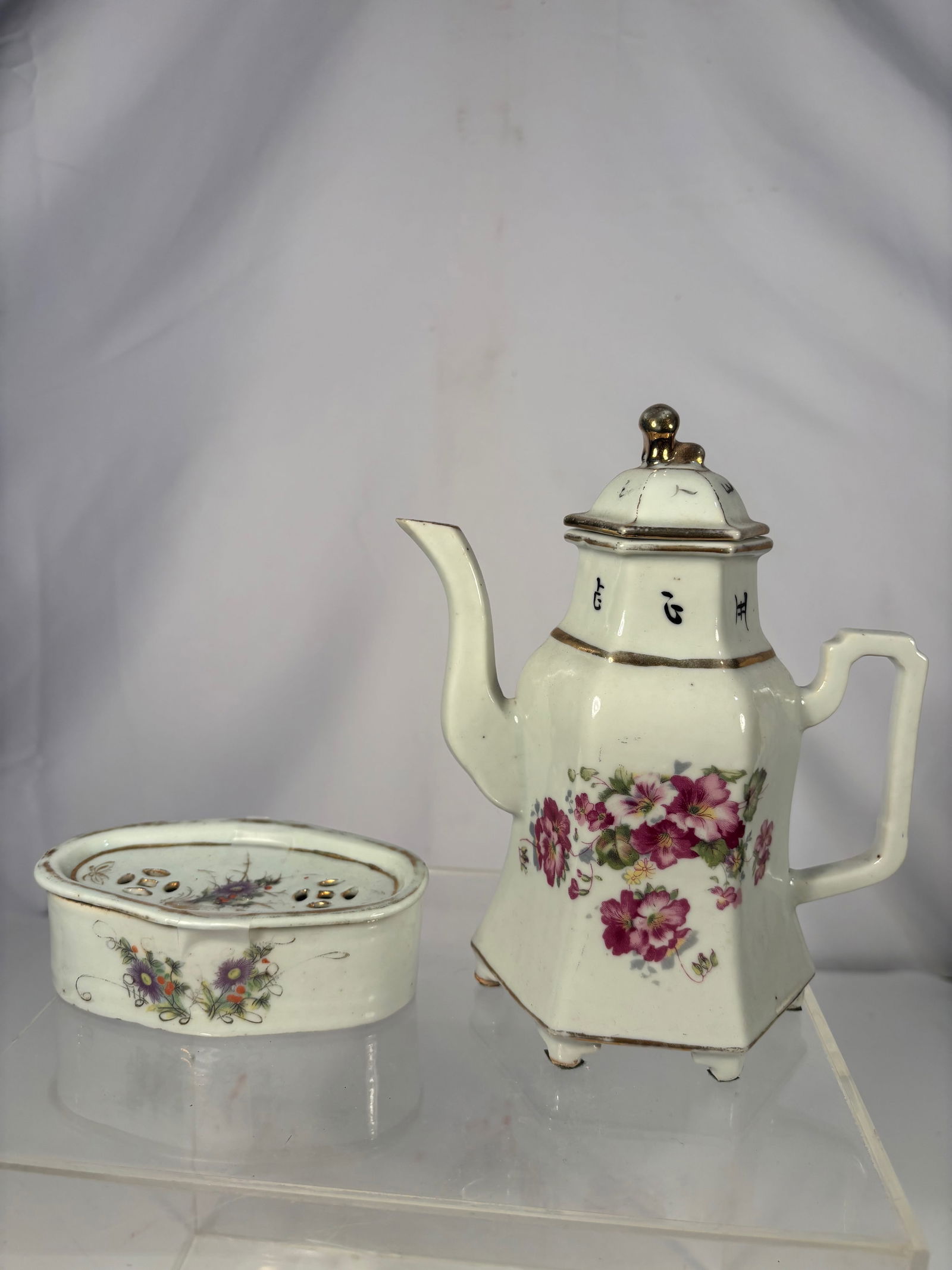 Chinese Porcelain Hexagonal Teapot with Warming Tray, Floral Decoration: 19th century; Chinese porcelain teapot with matching warming tray, featuring hand-painted floral decoration in soft famille-rose style enamels. The teapot is hexagonal in form, raised on six small fee