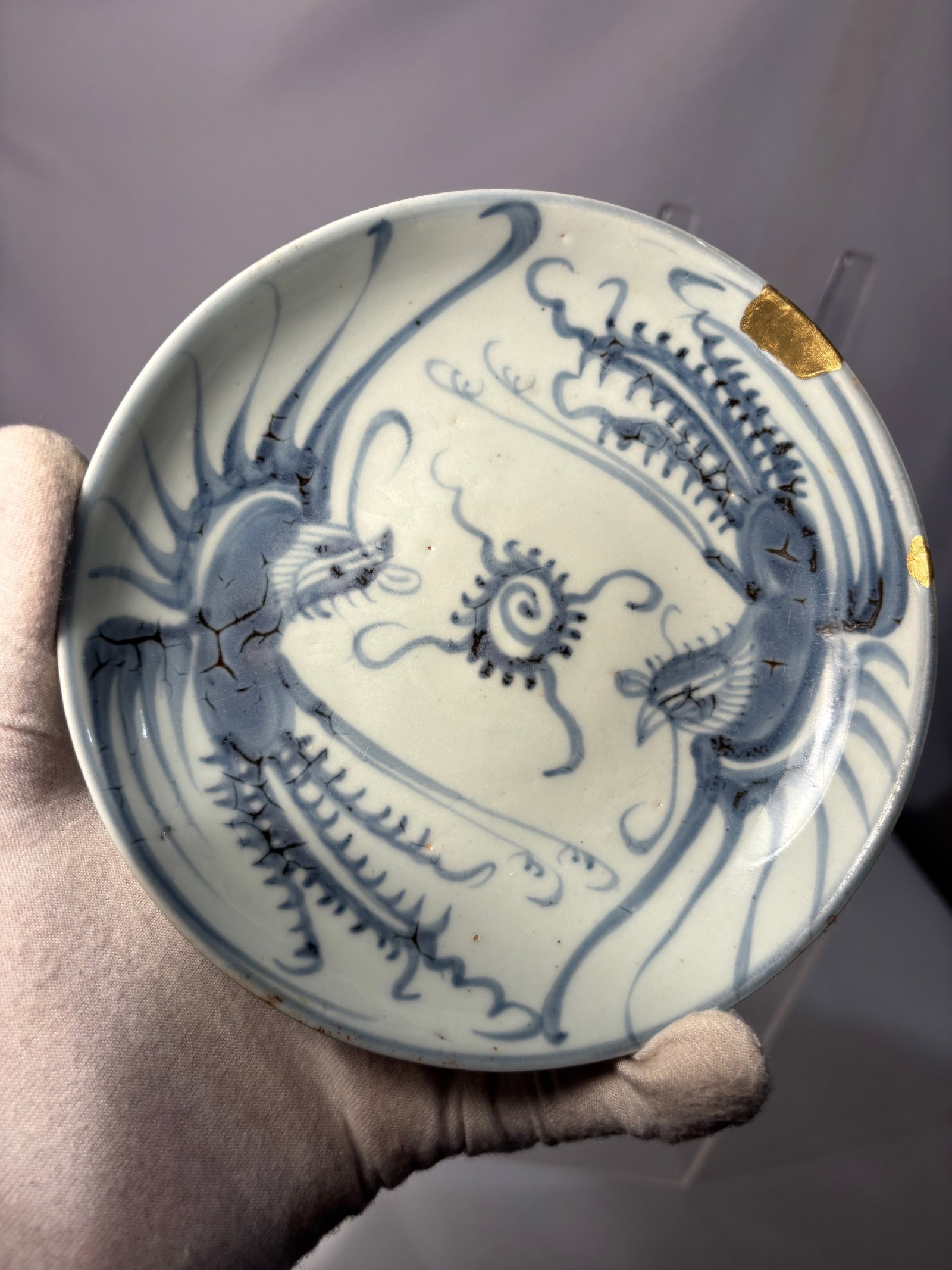 A Chinese Blue and White Dragon Plate, Possibly 17th Century: A Chinese blue and white porcelain plate decorated with a dynamic dragon motif in underglaze cobalt blue. The interior features a vigorously rendered dragon chasing a flaming pearl amid scrolling clou