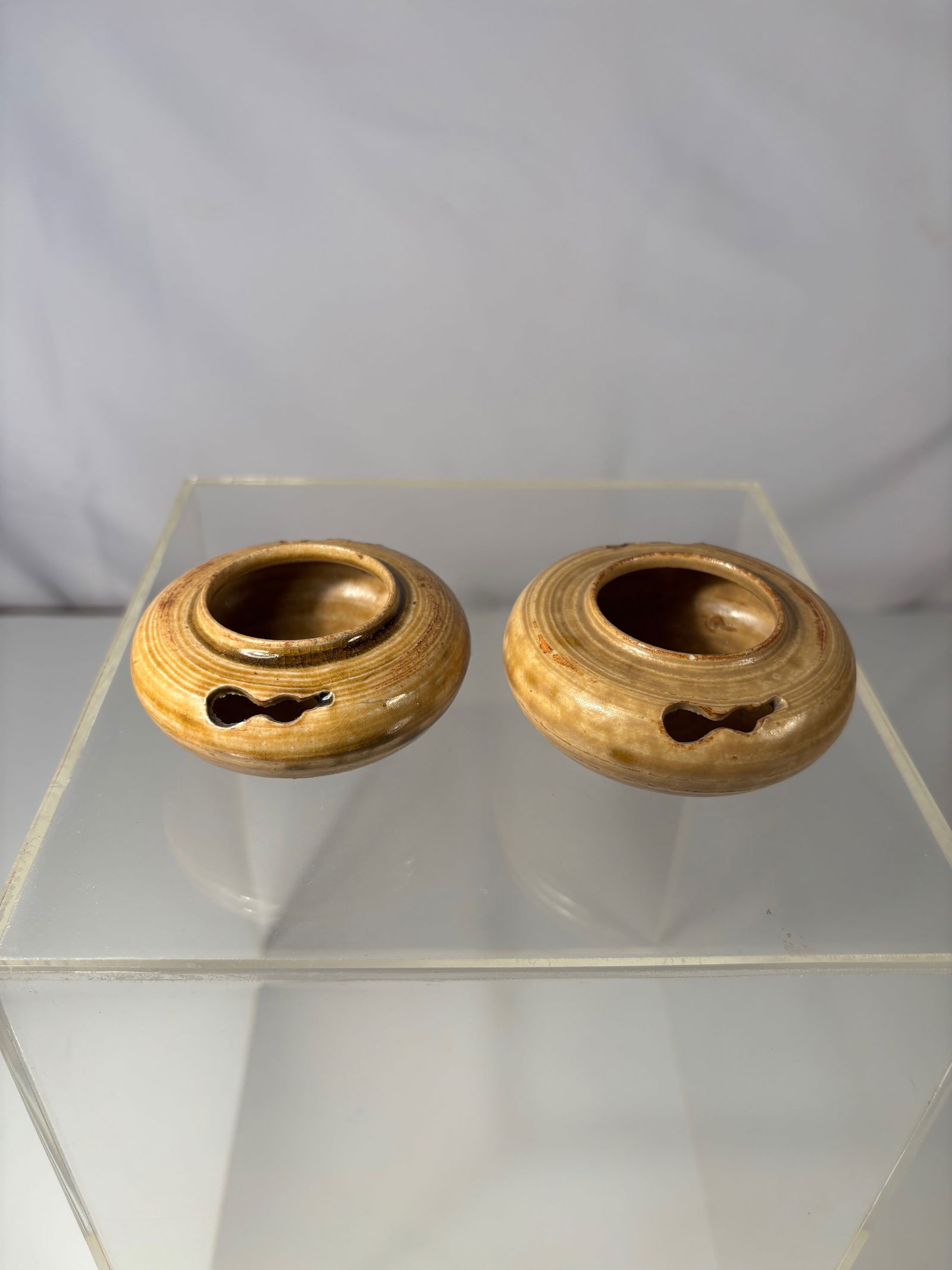 A Pair of Chinese Cizhou-Type Glazed Water Droppers: Qing Dynasty (1644-1912);A pair of small Chinese Cizhou-type stoneware water droppers, each of compressed globular form with circular banded decoration, the amber-brown glaze thinning at the rims and