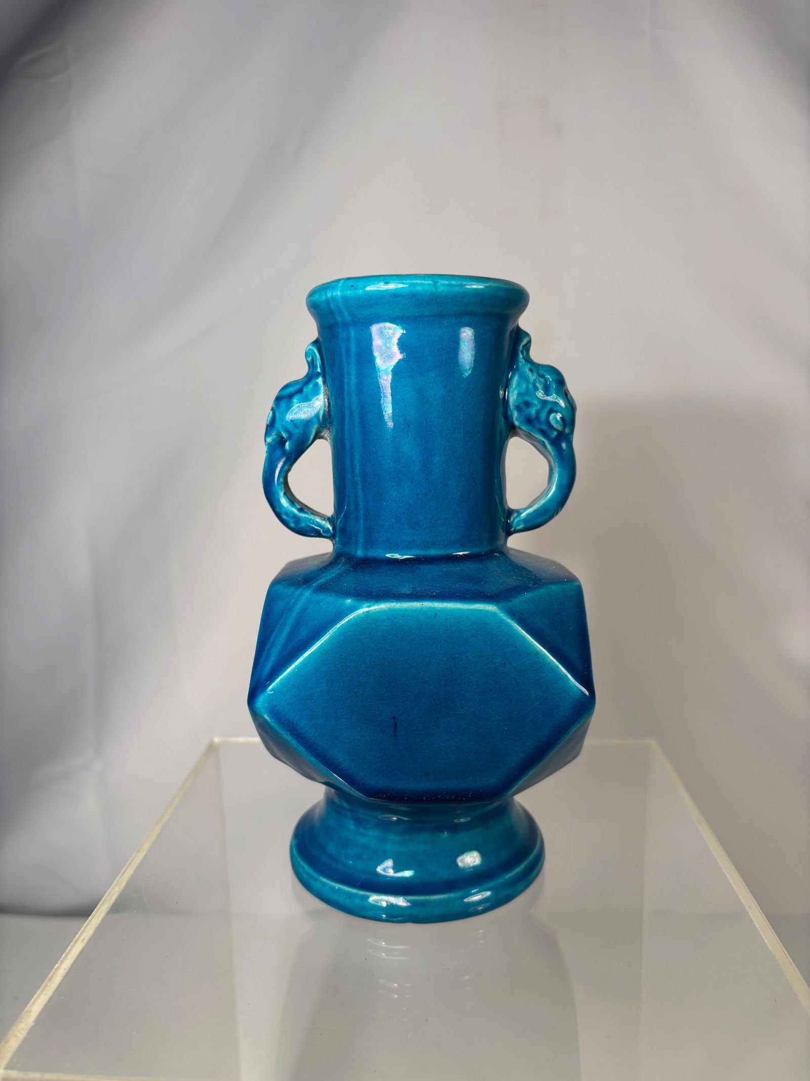 A Chinese Turquoise-Glazed Hexagonal Porcelain Vase with Beast-Mask Handles with QIANLONG Mark: Qing Dynasty (1644-1912); A Chinese turquoise-glazed porcelain vase of hexagonal faceted form, featuring a tall cylindrical neck with a flared rim. The body is fitted with a pair of applied beast-mask