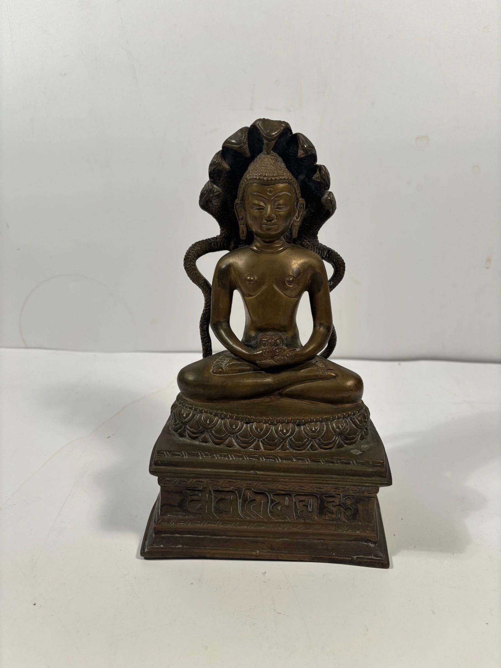 A bronze statue of the Buddha sheltered by the Naga (serpent) Mucalinda (1 of 12)