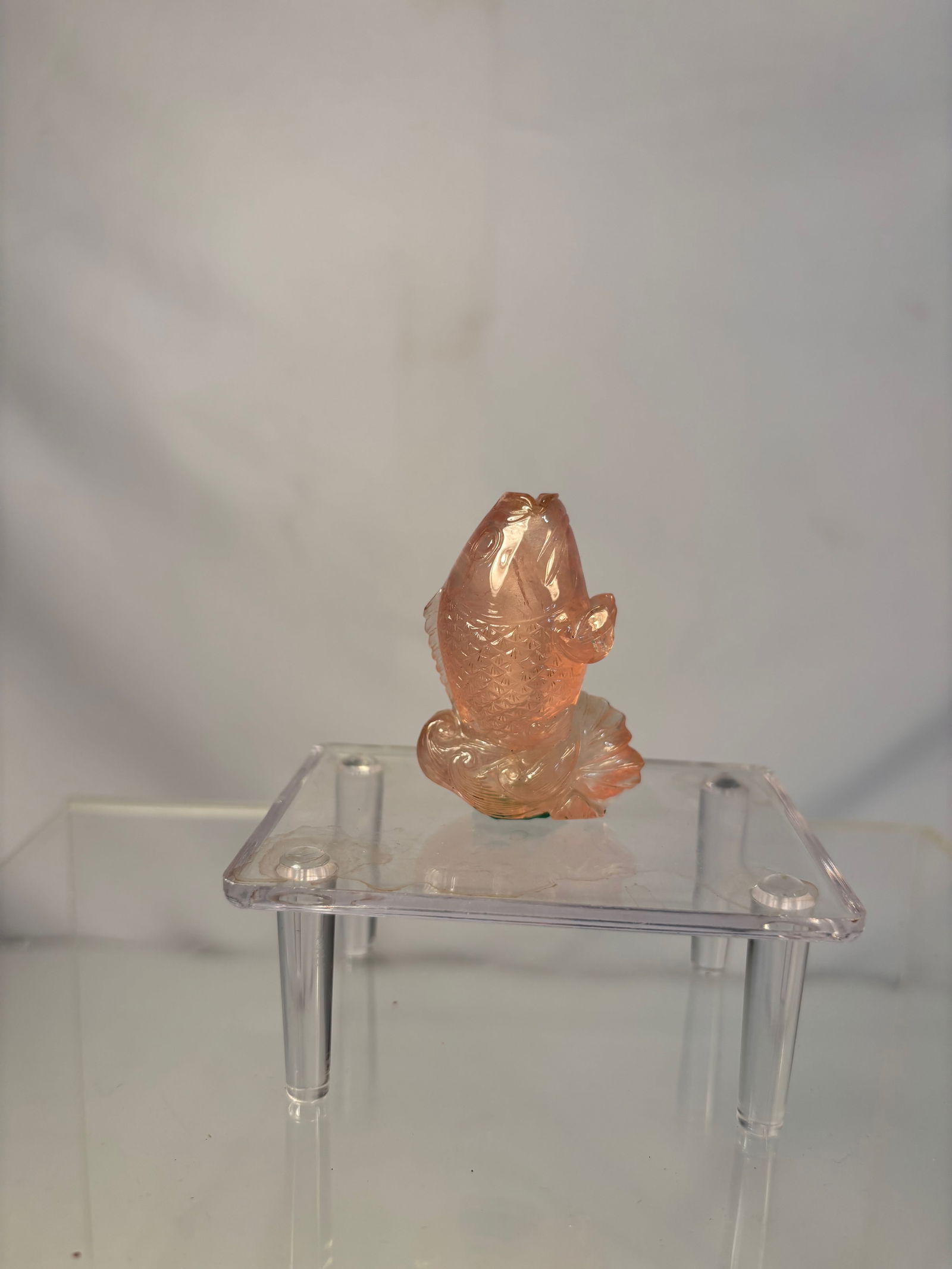 A Chinese Rose Quartz Fish-Form Snuff Bottle: Antique Chinese Composition Doll with Original Silk Costume, Early 20th CenturyDelicately carved from pale pink rose quartz in the form of a fish rising from stylized waves, the body finely detailed w