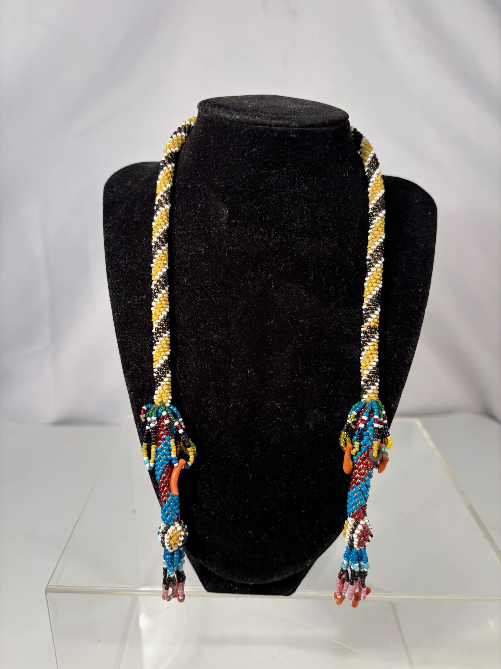 A Native American Plains Beaded Necklace with Coral, Tubular Peyote Stitch, c. 1900: Native American beaded necklace, likely Plains or Great Lakes region, dating to the late 19th or early 20th century. The necklace is constructed with a tubular peyote-stitched neck ring in yellow,