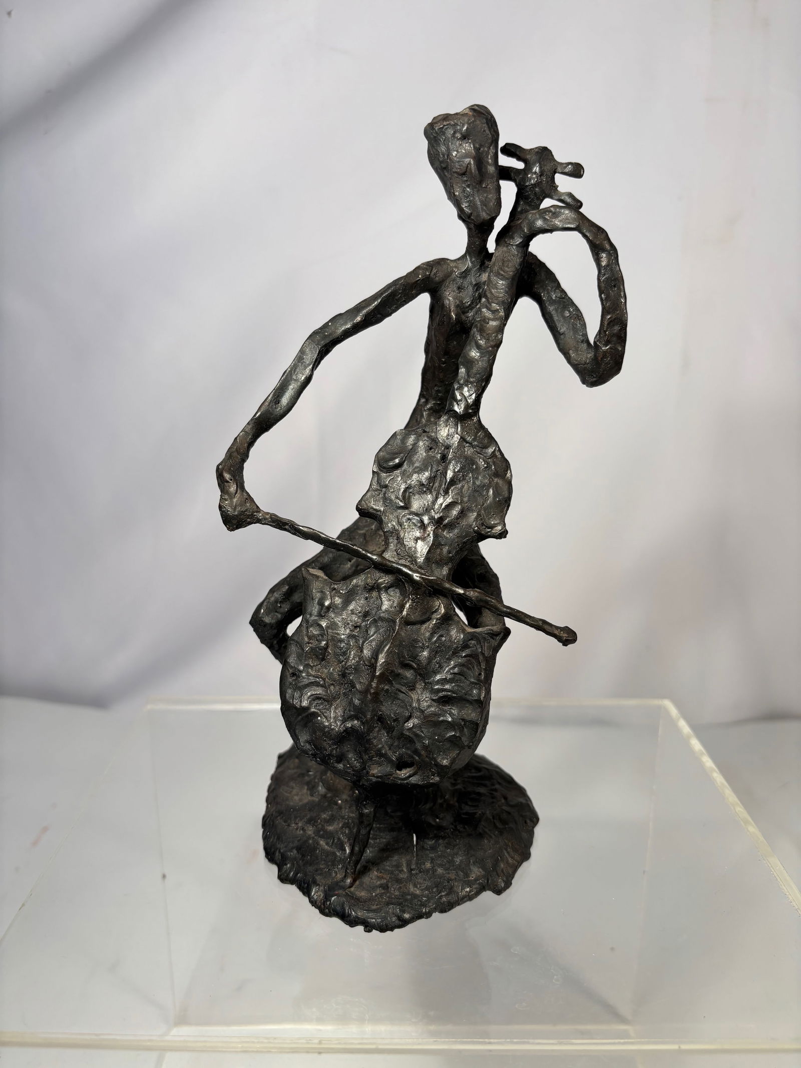 a Expressionist Bronze Figure, Signed “LJK: Cast bronze sculpture depicting an elongated standing human figure rendered in a highly expressionist style. The surface is deliberately rough and heavily worked, emphasizing gesture, movement, and ps