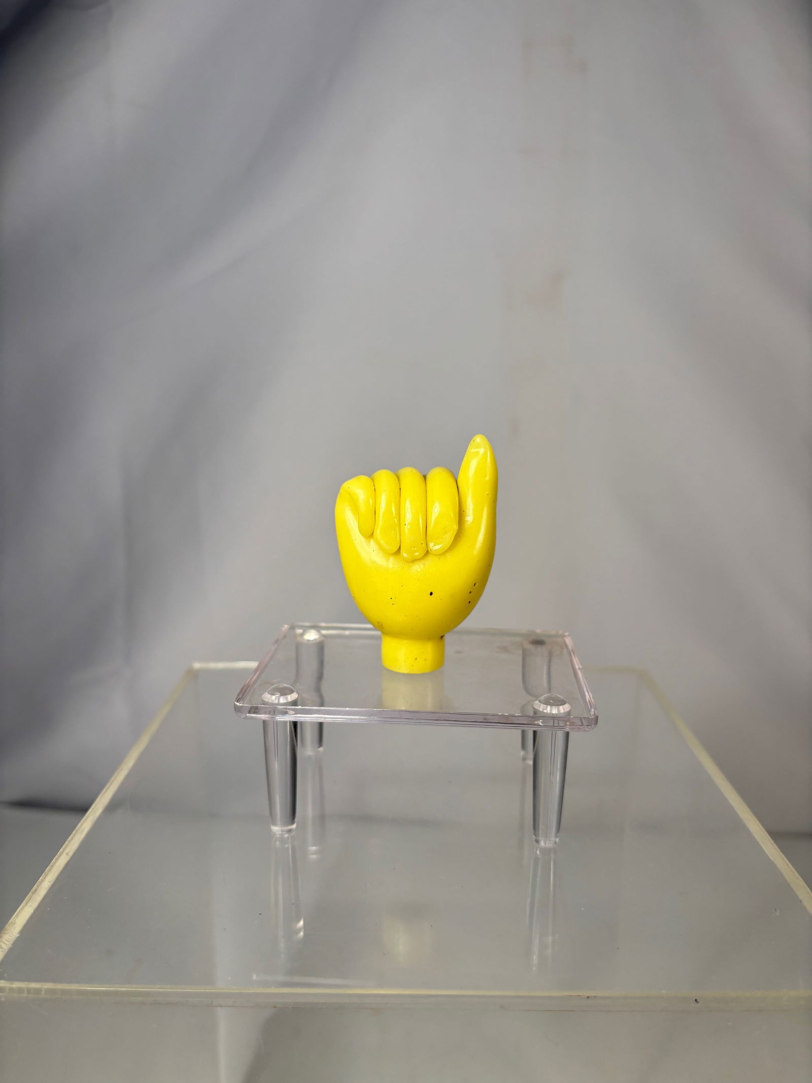 A Rare Chinese Yellow Glass Figural Hand-Form Snuff Bottle: Qing Dynasty (1644-1912); A Chinese yellow glass snuff bottle carved in the form of a stylized hand with the index finger raised. The bottle is hollowed from the interior, with a circular mouth at