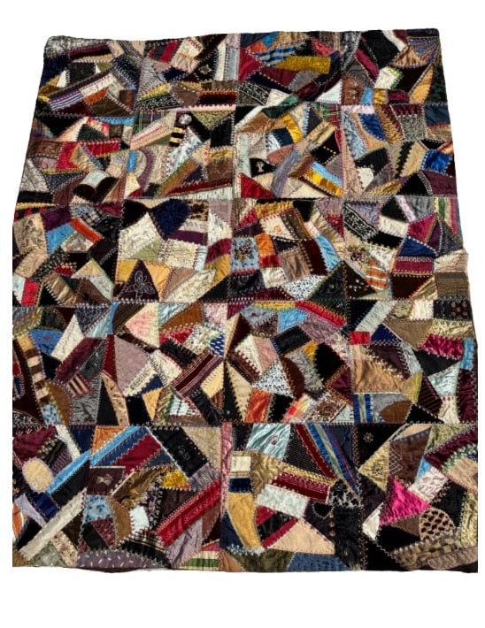 Victorian Crazy Quilt, Silk and Velvet, Embroidered Date ‘1887’: A richly embellished Victorian “crazy quilt” dated 1887, constructed from an array of luxurious fabrics including silk, velvet, and satin. The quilt features intricate hand embroidery in a var