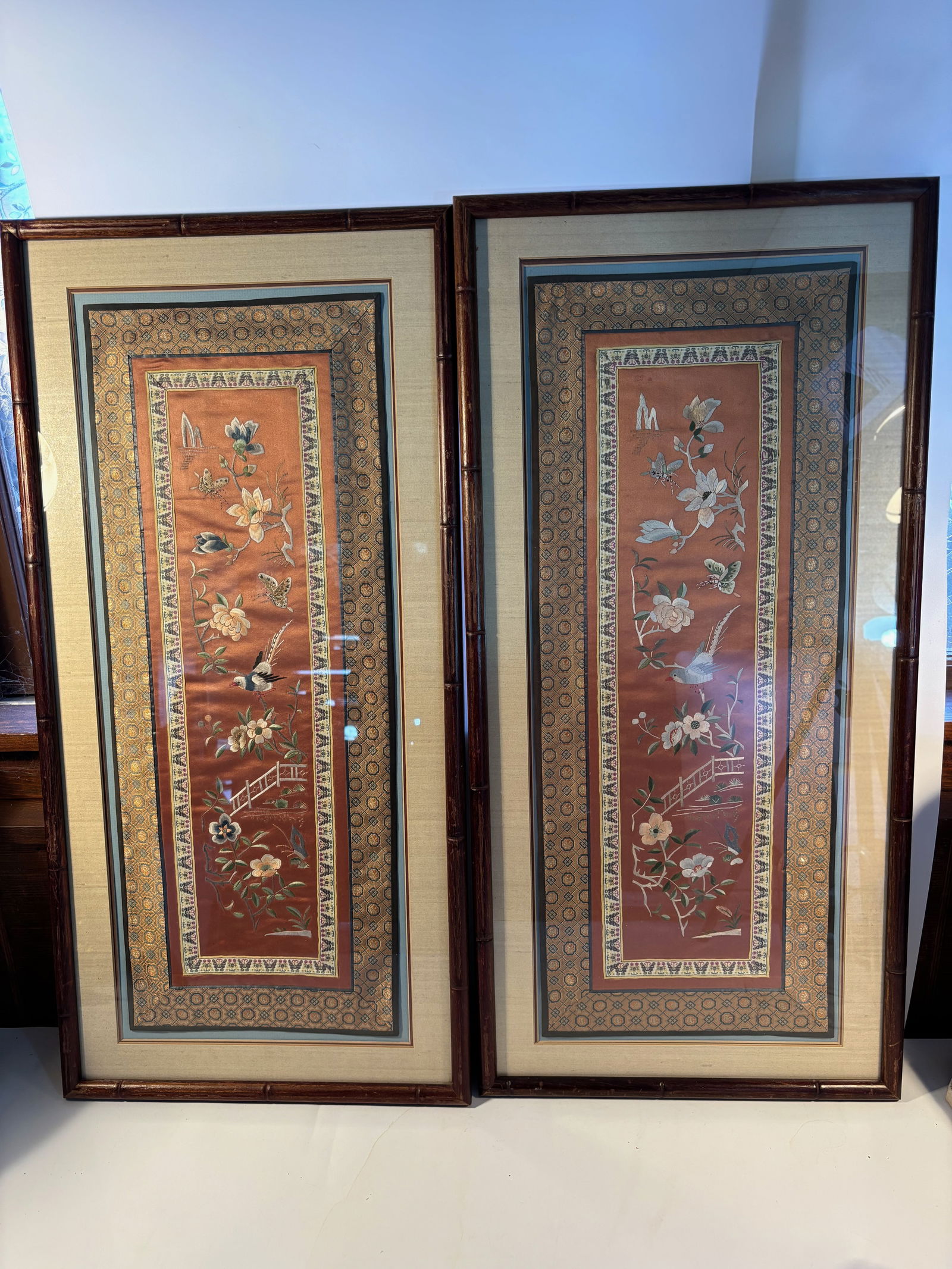 A pair of Chinese silk embroidery panels: Qing Dynasty (1644-1912) ;The embroidery depicts flowers, butterflies, and birds. Dimensions?Frame Length: 31INCHES; Width: 15 inches.