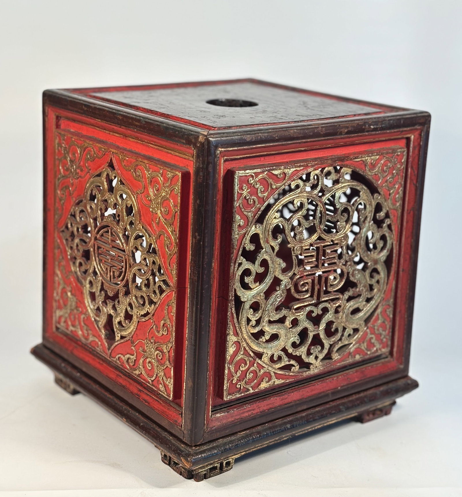 A Chinese Gilt and Red Lacquer Pierced SEAL Box: Qing Dynasty (1644-1912); A finely crafted Chinese red and gilt lacquer hardwood box, likely Qing Dynasty style, of square form with pierced and carved panels on all four sides. Each panel features