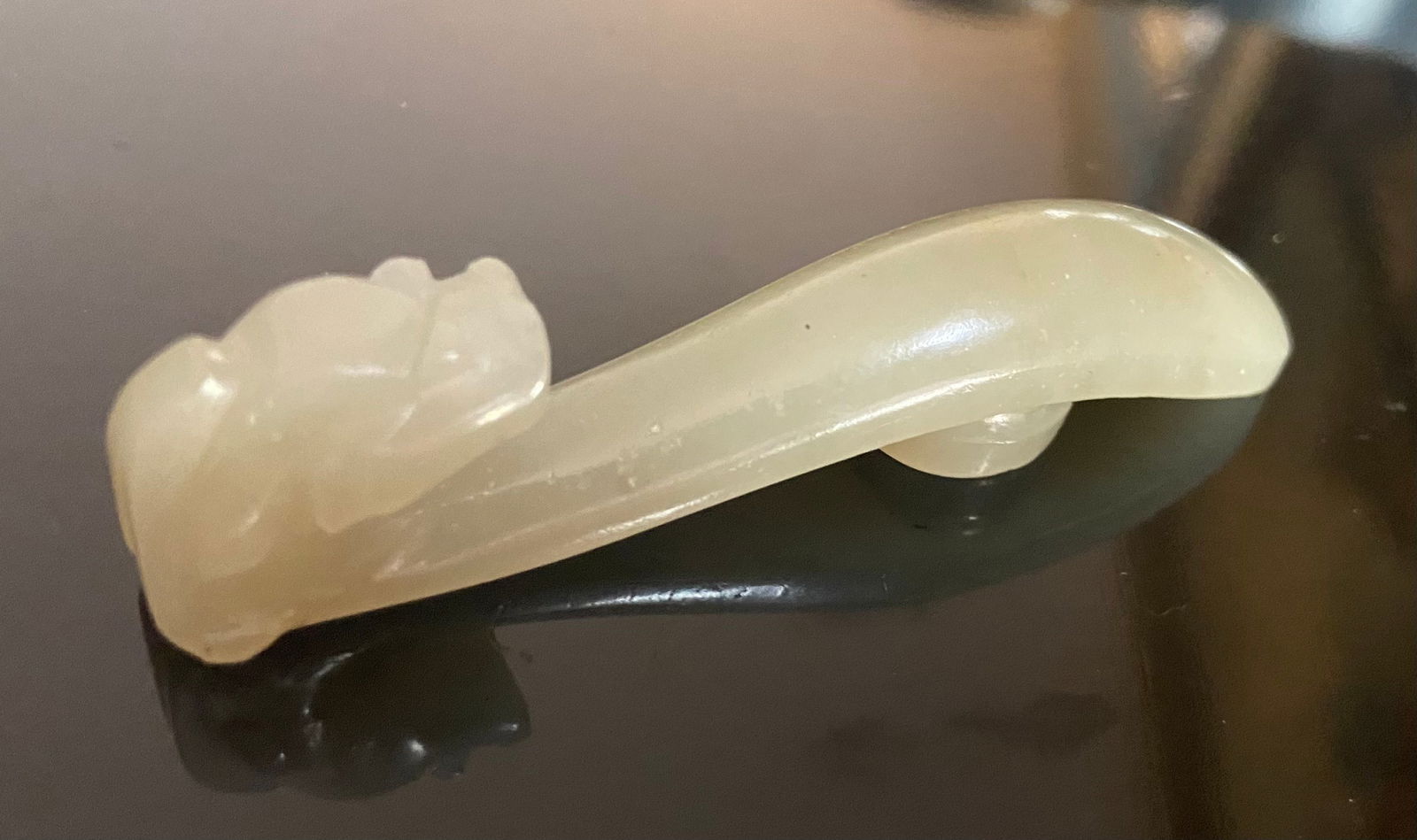 A Chinese Nephrite jade dragon buckle: Qing dynasty(1644-1912) ; The color of the jade is a light, creamy green with some darker inclusions, which is characteristic of nephrite jade.Length: 8cm .